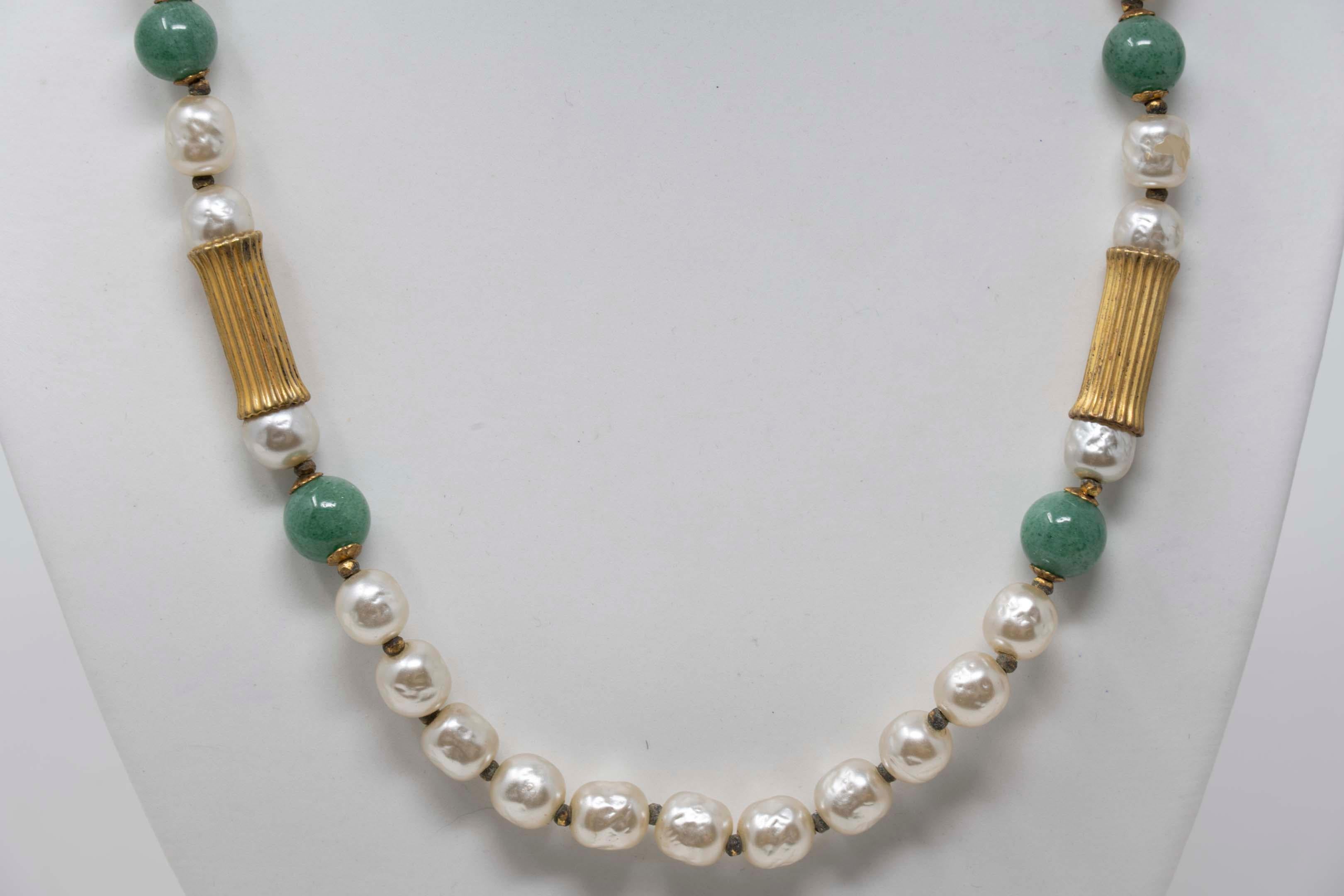 Vintage 1950 Miriam Haskell necklace with faux pearls, jade and metal gilt tube. Measures 28 inches long x .4 inches wide. Made in the USA, circa 1950. In good condition, signed on the clasp.
