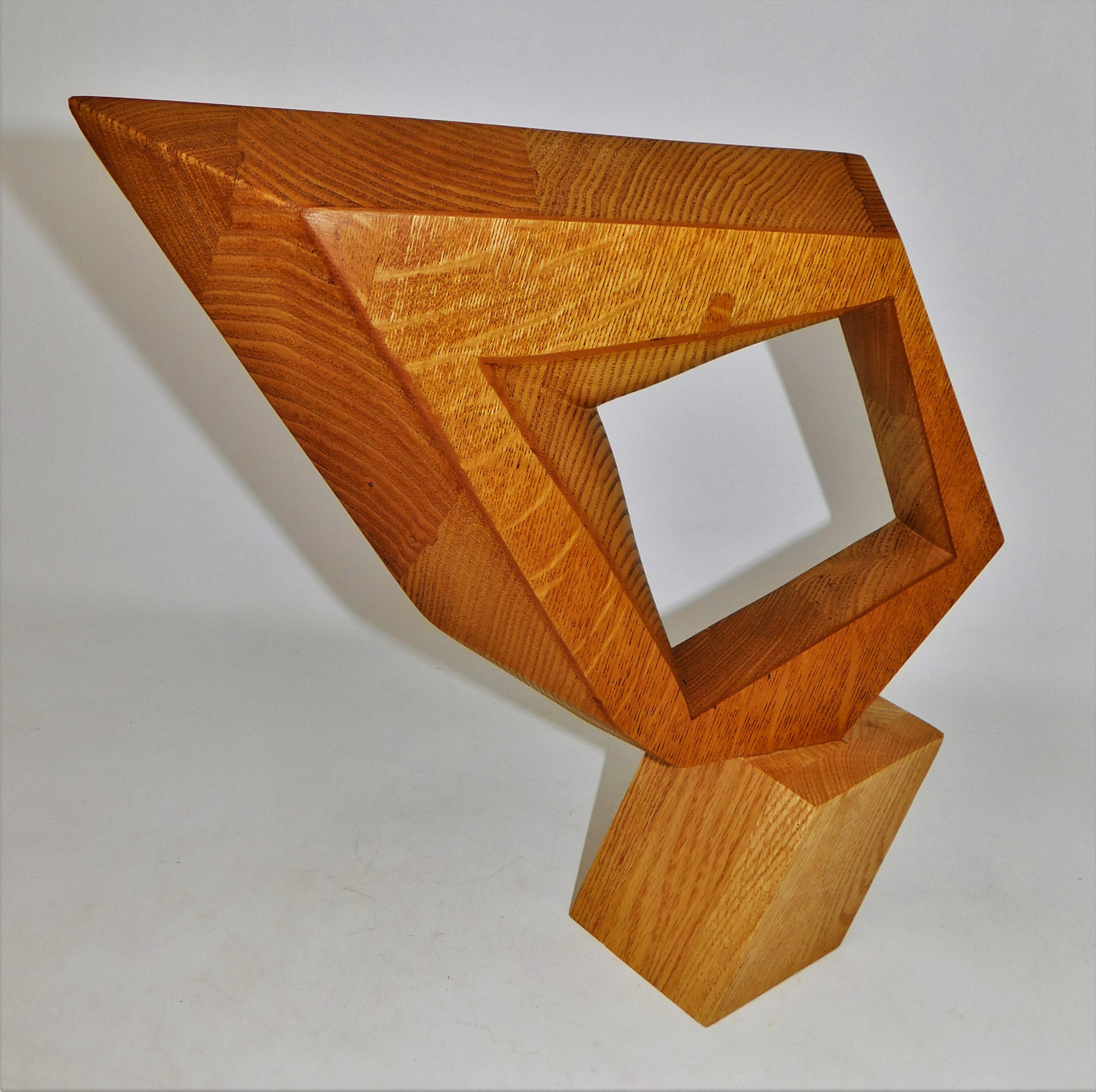 This contemporary abstract wooden sculpture was done by Czeslaw Budny a Polish-Canadian artist in the constructivist style circa 2023. This sculpture was made entirely of up-cycled, reclaimed wood from a variety of sources and utilizes the
