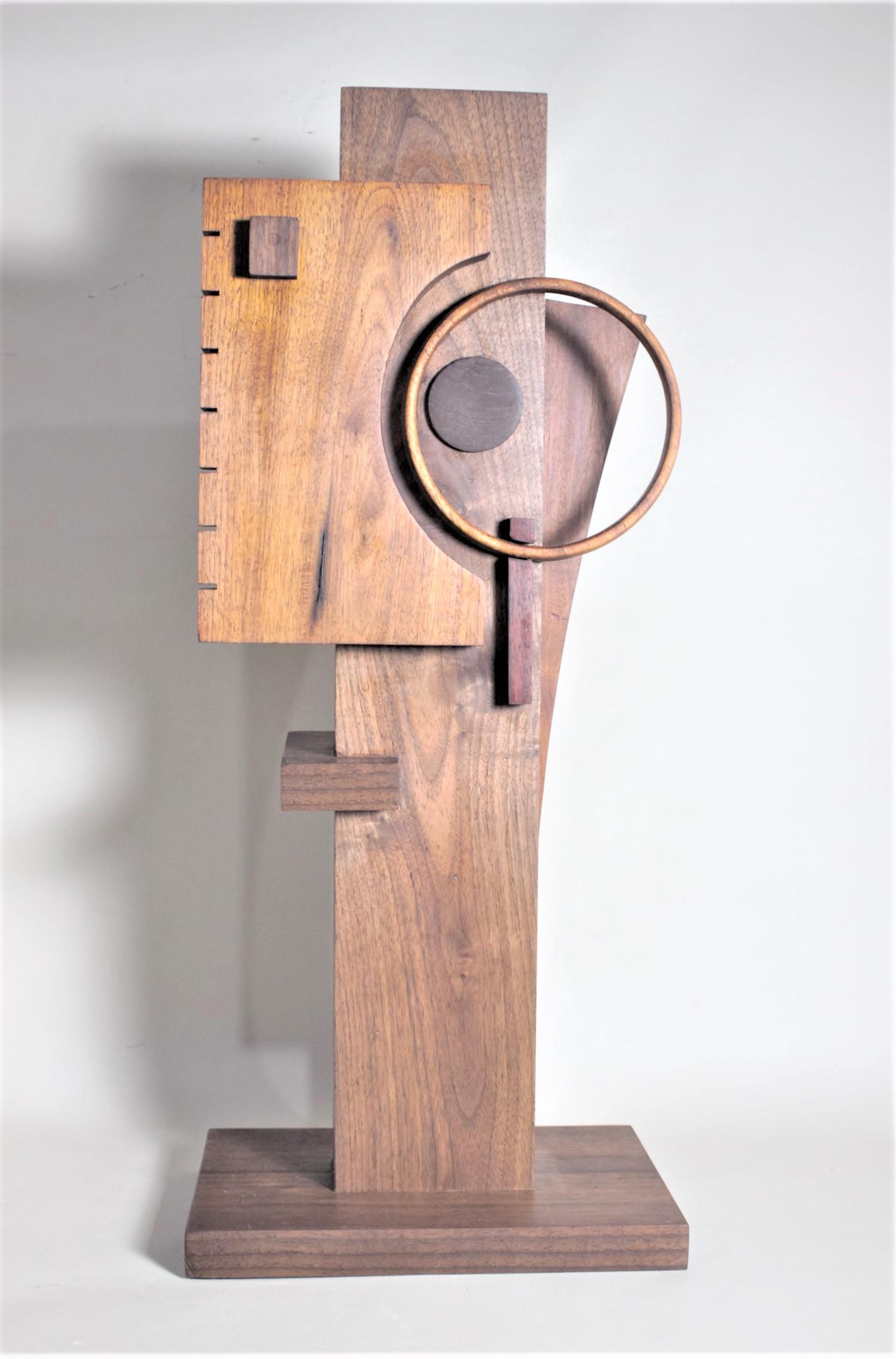This contemporary abstract wooden sculpture was done by Czeslaw Budny a Polish-Canadian artist in the Constructivist style in circa 2010. This sculpture was made entirely of up-cycled, reclaimed wood from a variety of sources and utilizes the