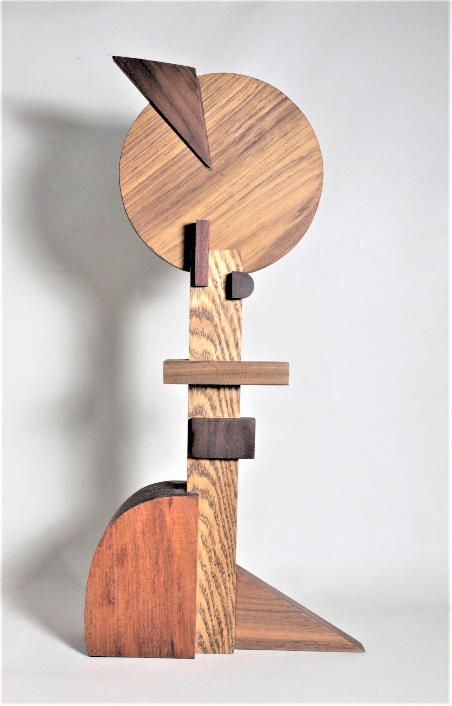 This contemporary abstract wooden sculpture was done by Czeslaw Budny a Polish-Canadian artist in the constructivist style in circa 2010. This sculpture was made entirely of up-cycled, reclaimed wood from a variety of sources and utilizes the