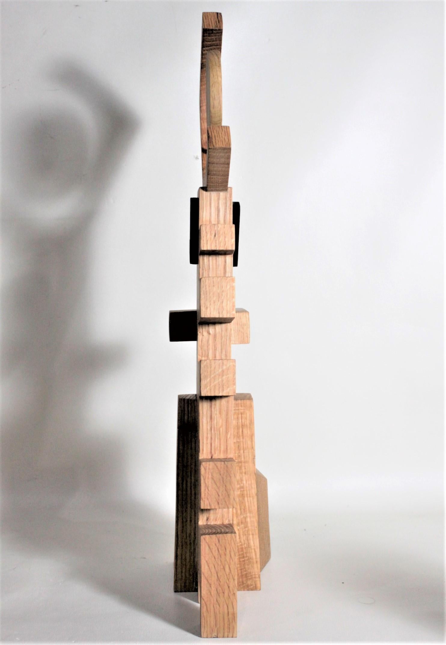 This contemporary abstract wooden sculpture was done by Czeslaw Budny a Polish-Canadian artist in the constructivist style in circa 2010. This sculpture was made entirely of up-cycled, reclaimed wood from a variety of sources and utilizes the