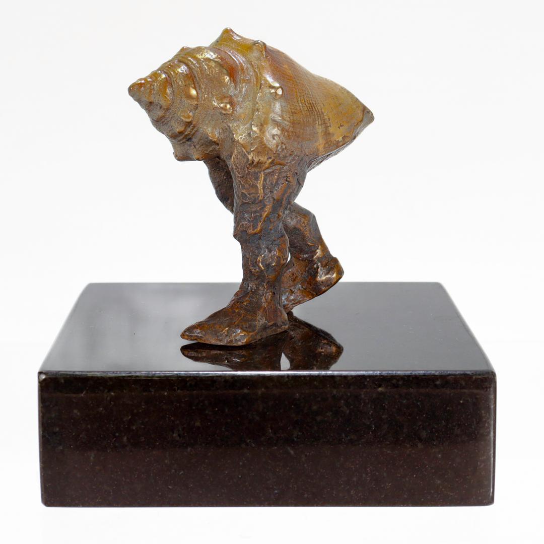 A fine, signed modernist (or surrealist) bronze sculpture.

Whimsically depicting a conch shell with legs in full stride.

The realistically modeled shell with a lighter ochre/brown patina and the legs with a darker chocolate brown patina.

Mounted