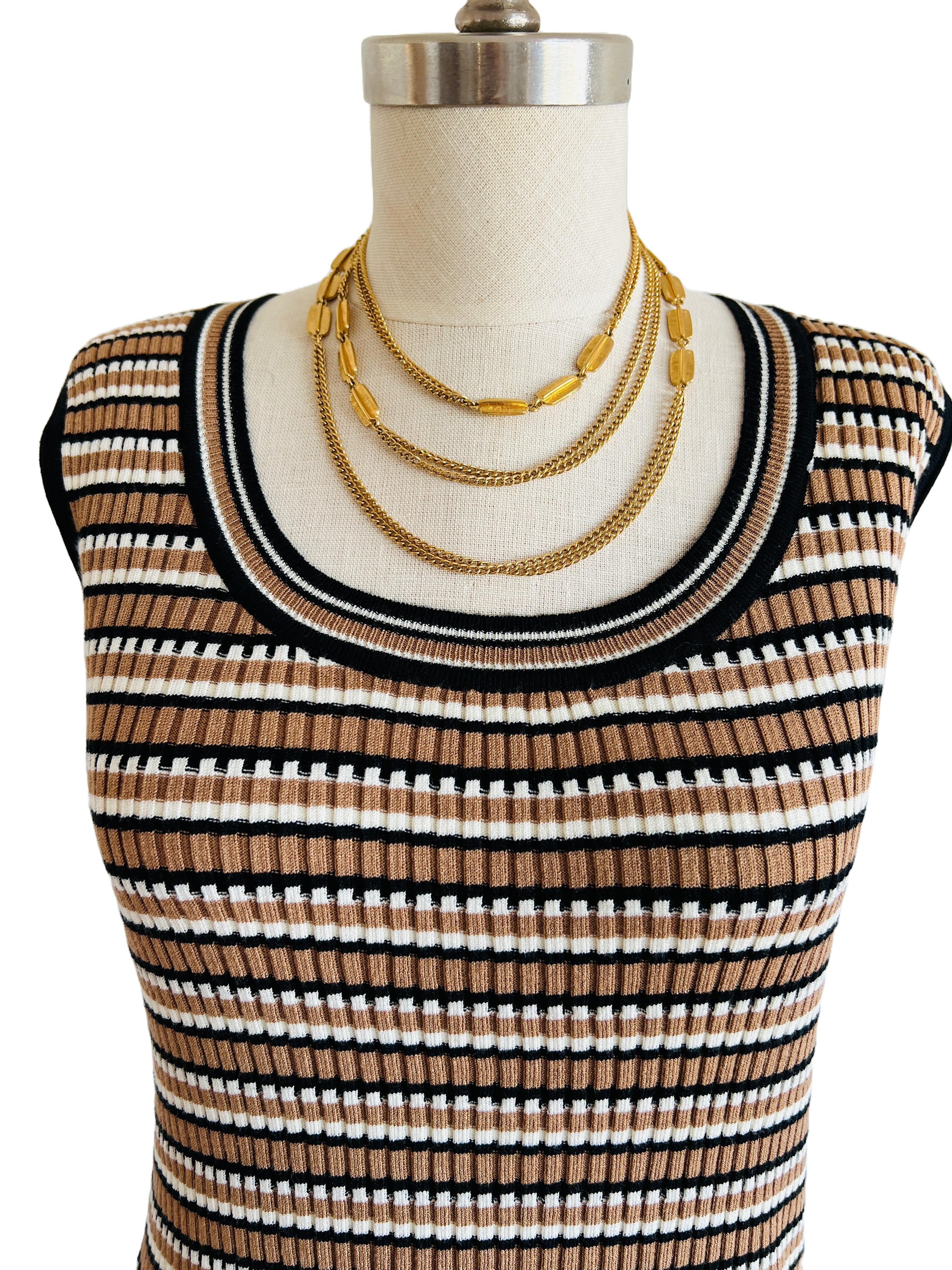 This lovely vintage Monet necklace, features a sophisticated double chain design that combines the timeless appeal of gold-tone curb links with textured oval accents. 

This versatile piece offers endless possibilities for styling.
The necklace can
