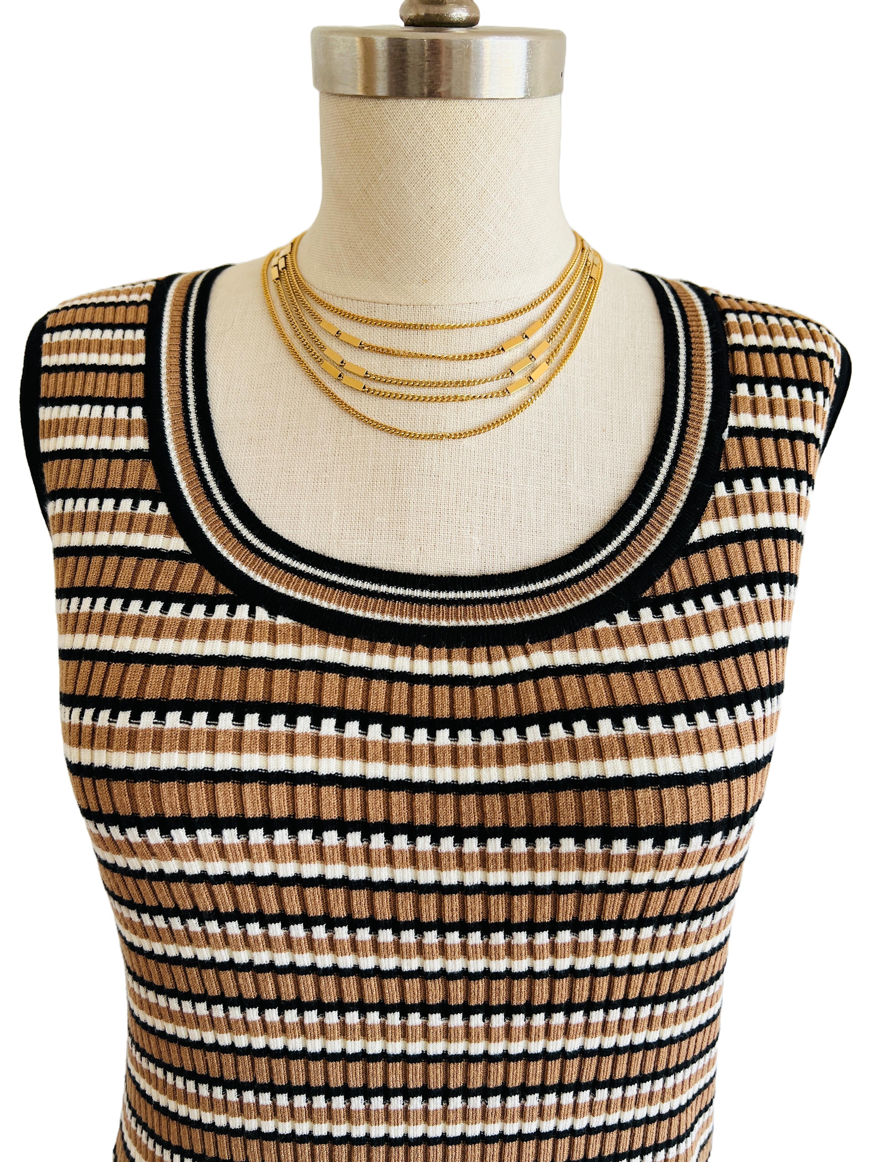 Embrace the timeless elegance of the vintage Monet 'Paulette' necklace, a signature piece from the iconic Fall 1976 collection. This exquisite necklace features five delicate gold-tone chains, each with a classic curb link design, carefully draped