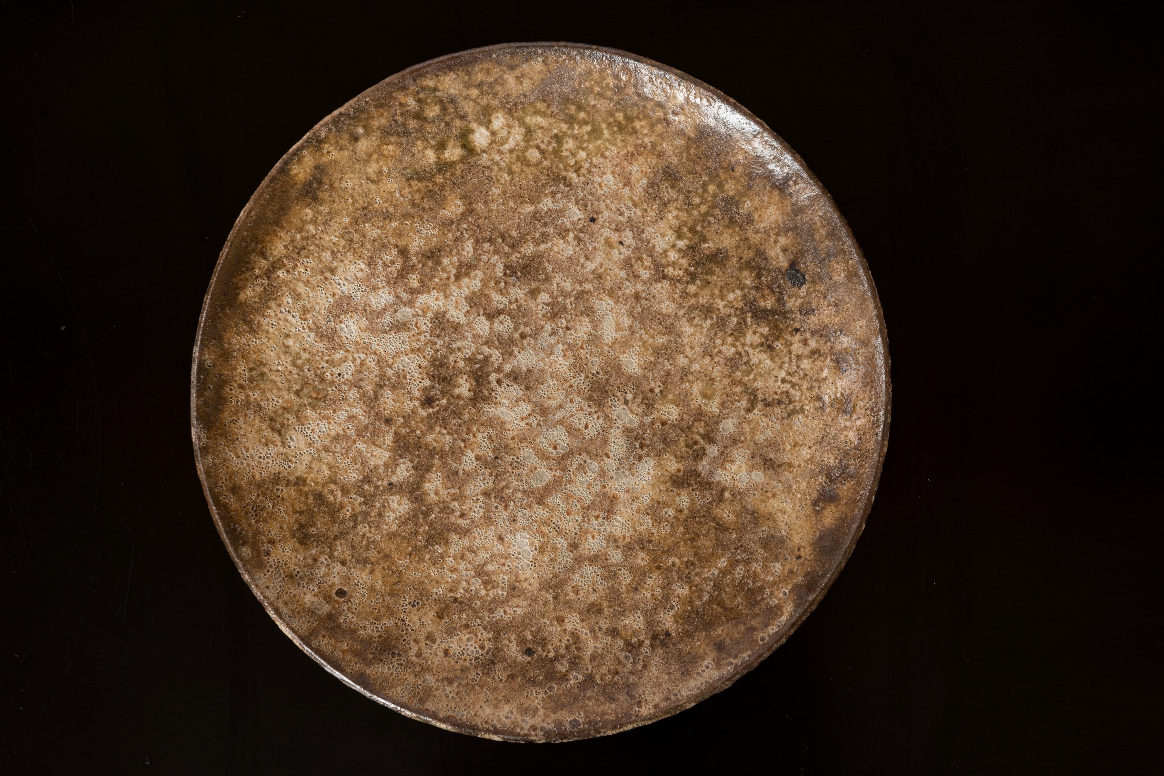 Circular plate-shaped dish with a textured ceramic design resembling the surface of the moon. By Alexandre Kostanda, Vallauris. 
Signed by the artist on the back.
In good vintage condition.
