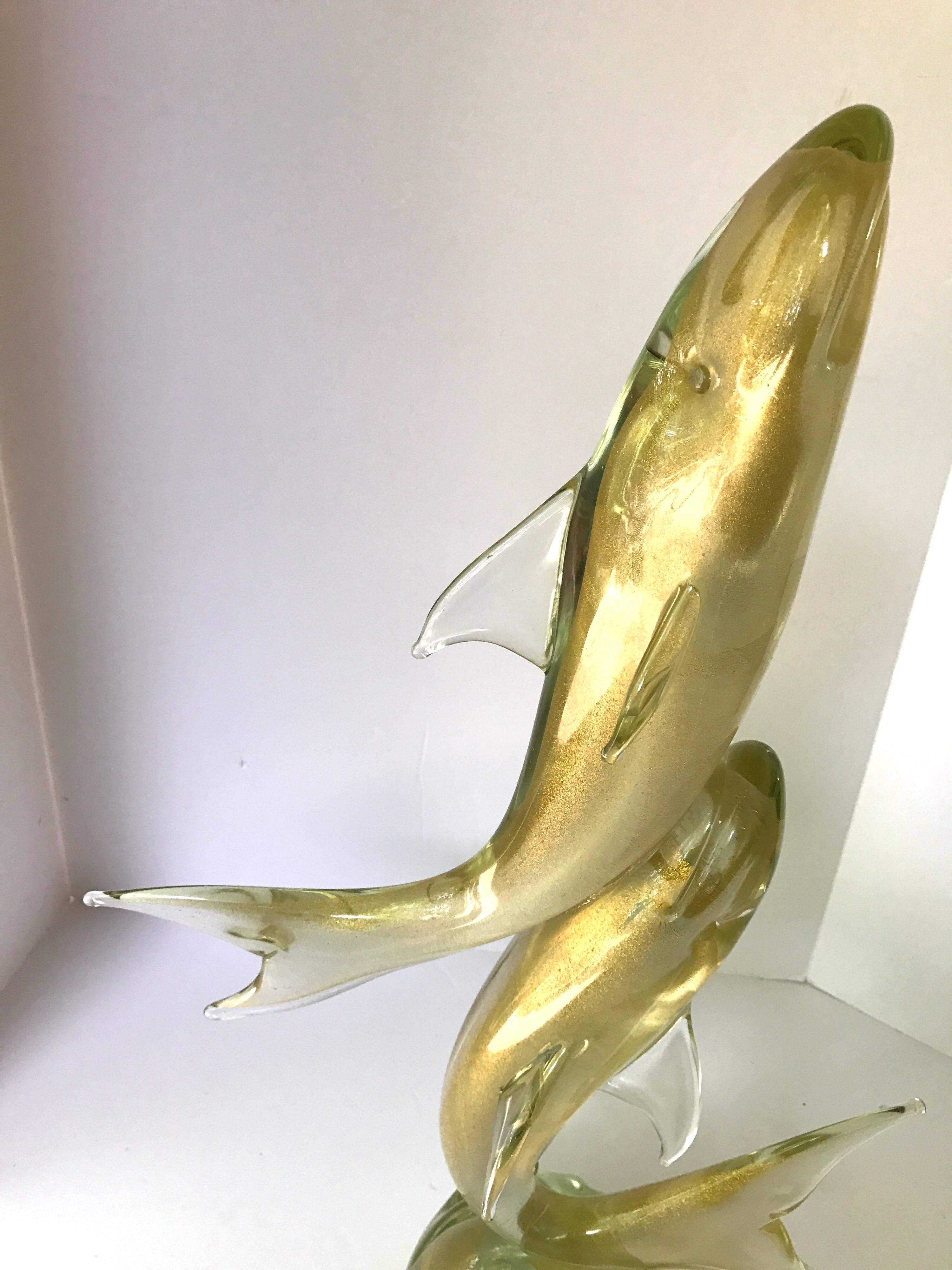 Standing twenty six inches tall, this golden Murano glass sculpture is guaranteed to set your home apart.
It is signed on the bottom and is in mint condition with a weight of close to forty pounds.
