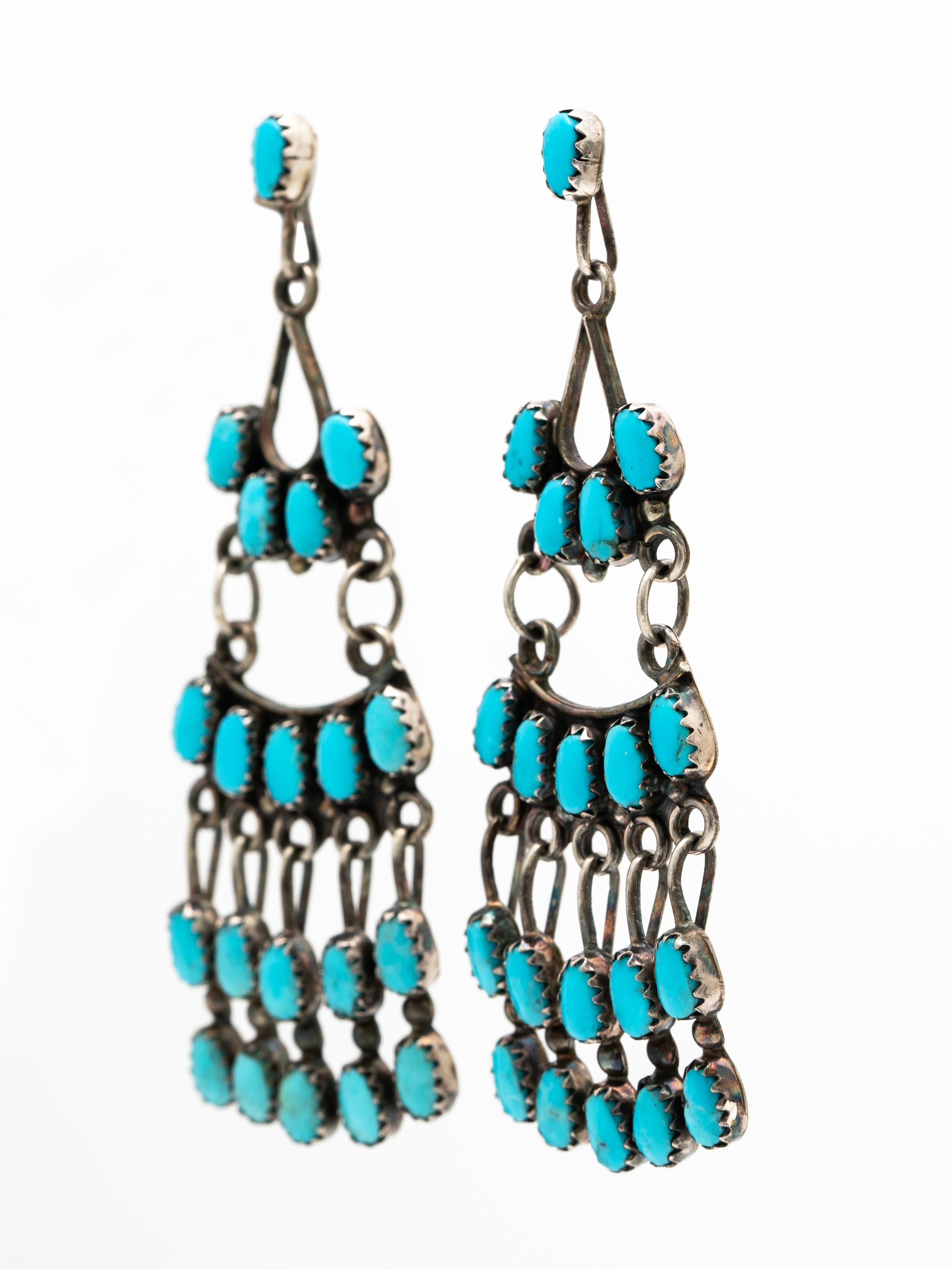 Signed Native American Zuni Silver and Turquoise Chandelier Fringe Earrings c.1970s

Beautiful, long and dramatic and influenced by Spanish jewelry

Length: 73.36mm
Width at widest point: 24.13mm
Weight per earrings: 7 grams
Signed: 
Zuni N.M (New