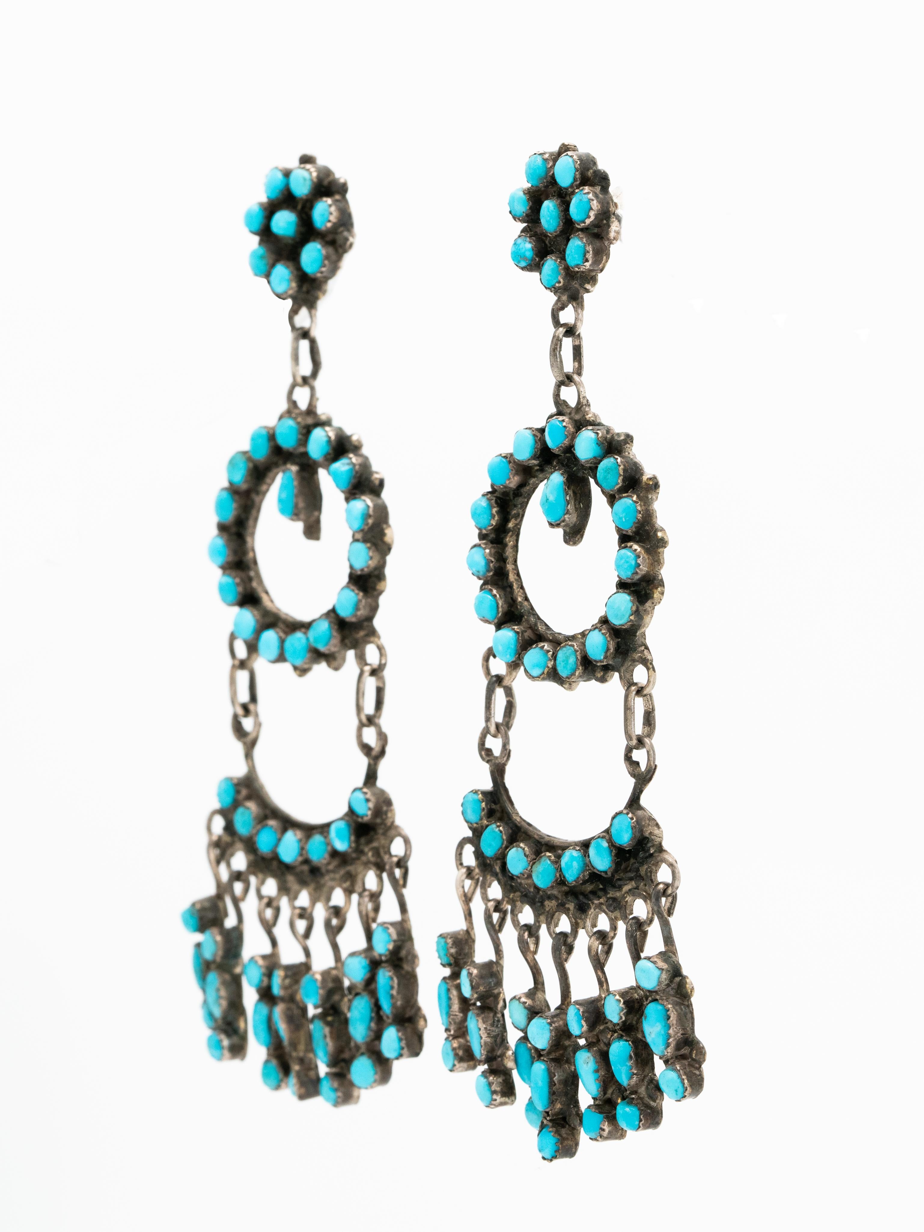 Signed Native American Zuni Silver and Turquoise Long Dangle Earrings c.1970s

Influenced by Spanish jewelry these dramatic vintage Zuni earrings are stunning. 

Length: 94.21mm
Width at widest point: 35.81mm
Weight per earrings: 12.3 grams
Silver