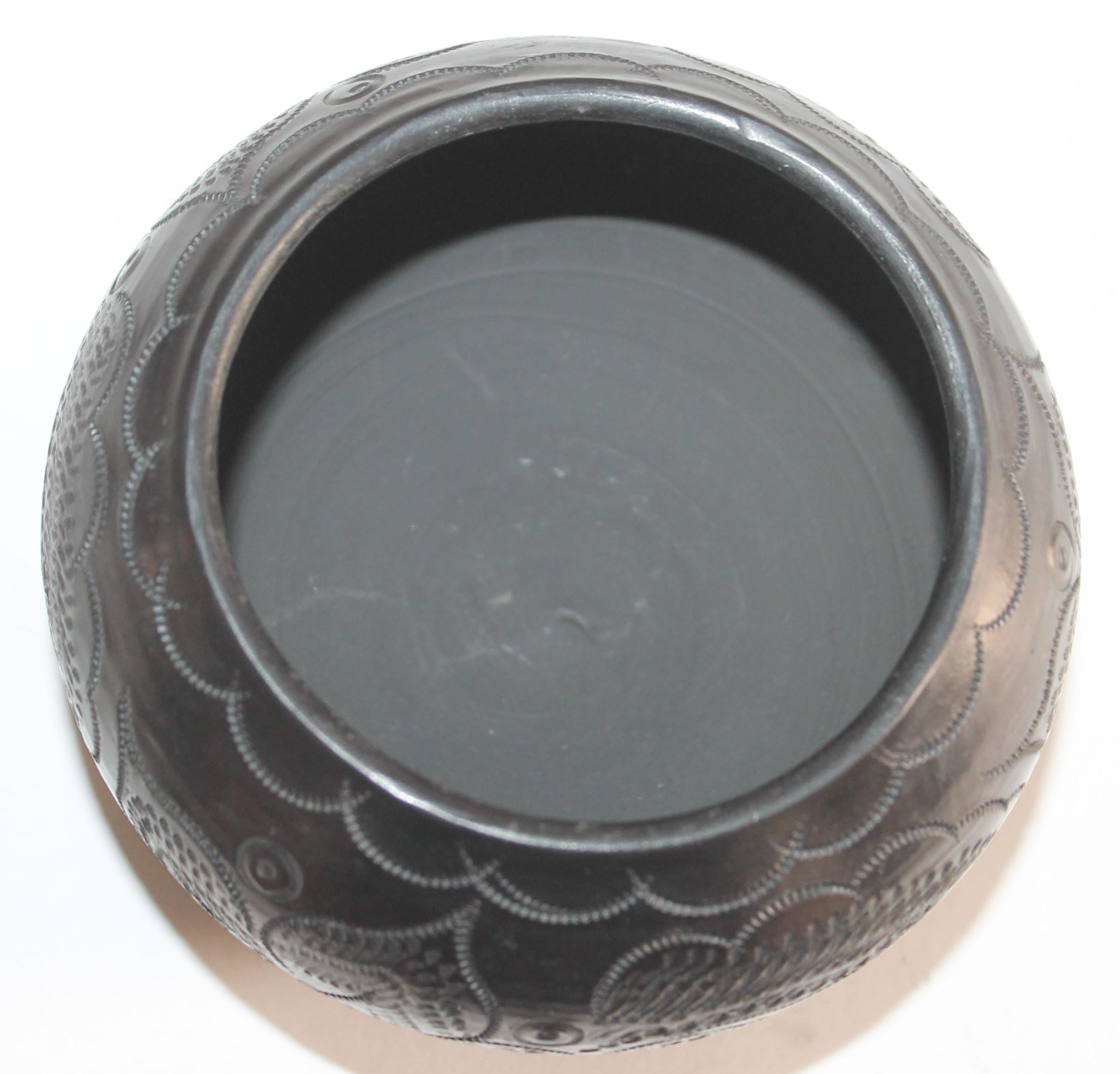 Signed Navajo Indian pottery bowl in fine condition. The black glazed pot.