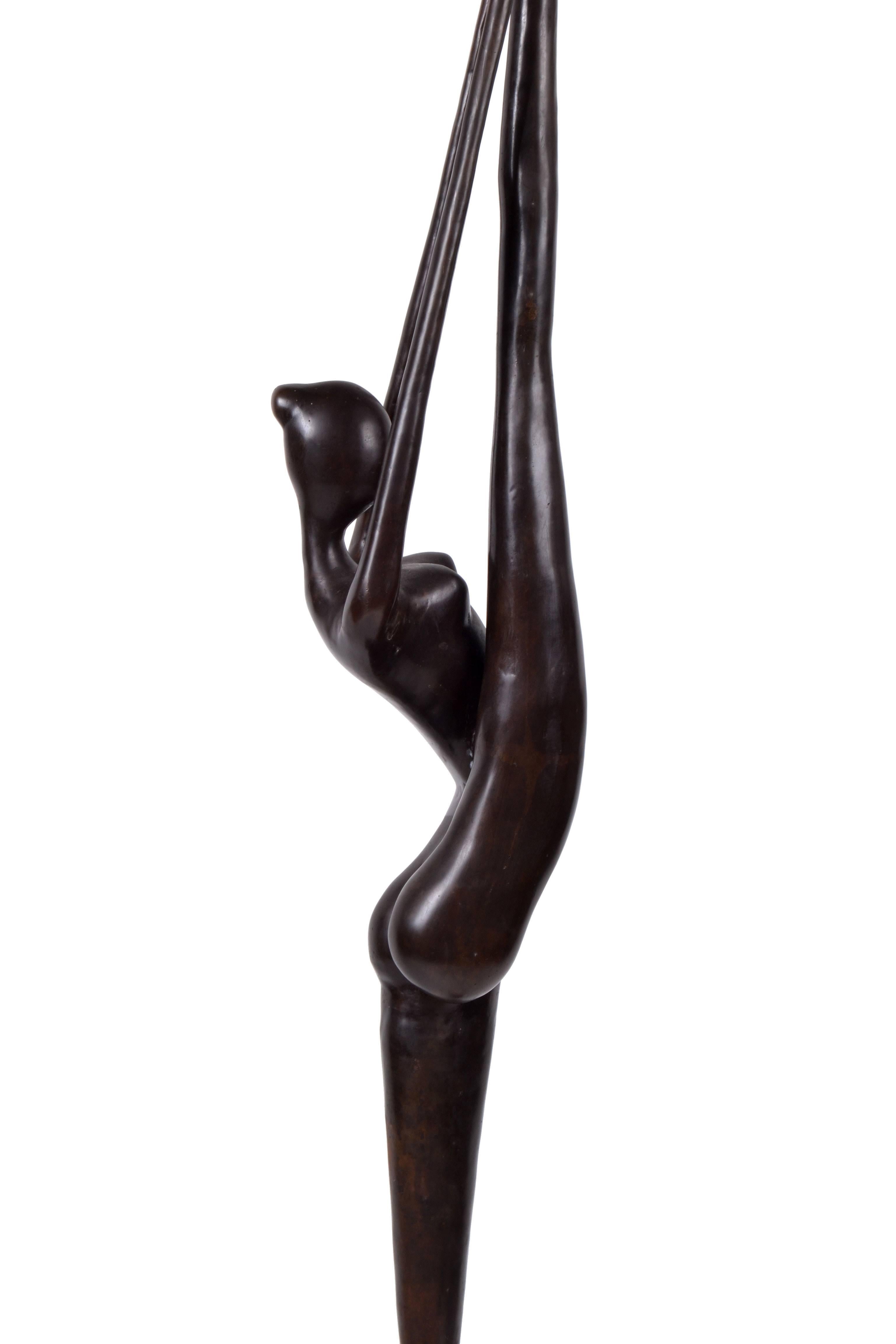 Tall signed bronze sculpture of a nude female dancer.
The dancer is mounted on a black marble base.
Signed illegibly and numbered 58/500.
  