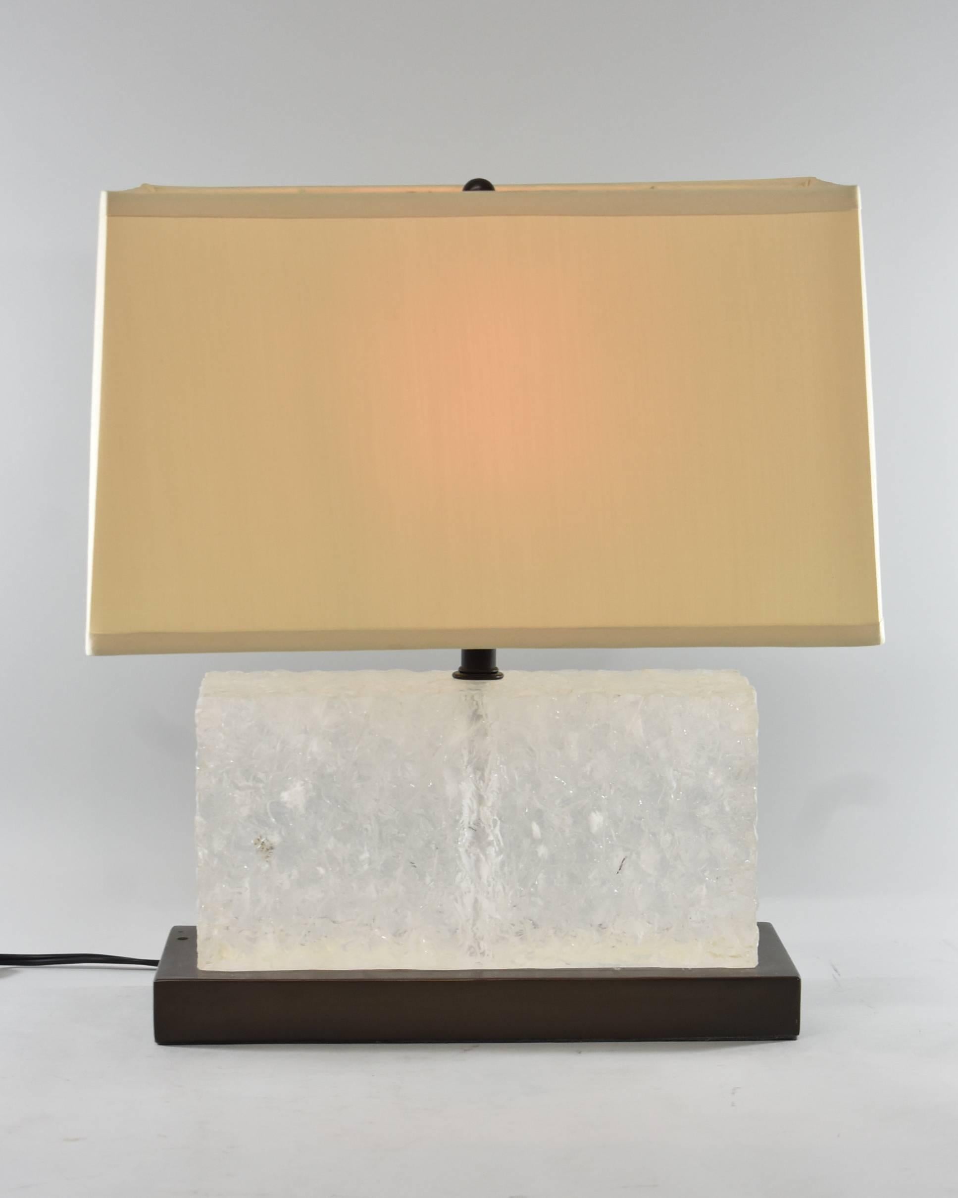 A splendid carved ice table lamp by Robert Kuo for McGuire, signed and numbered 3/19. This beautiful lamp features a hand-carved natural rock crystal on a copper base with a pongee silk shade that contrasts with the lamps unique materials.