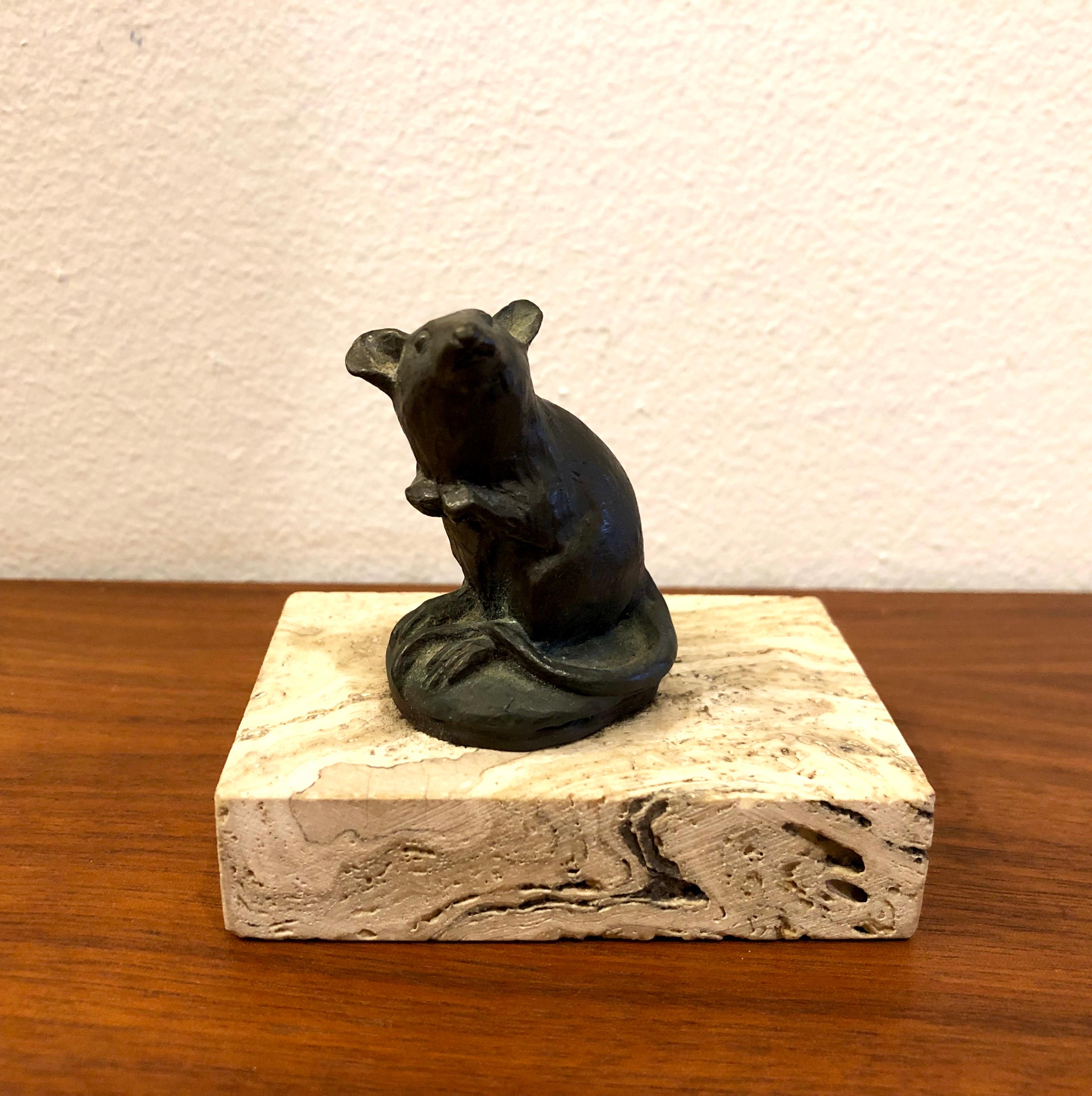 Petite solid bronze original sculpture by listed artist Siggy Puchta, sitting on a travertine Base.