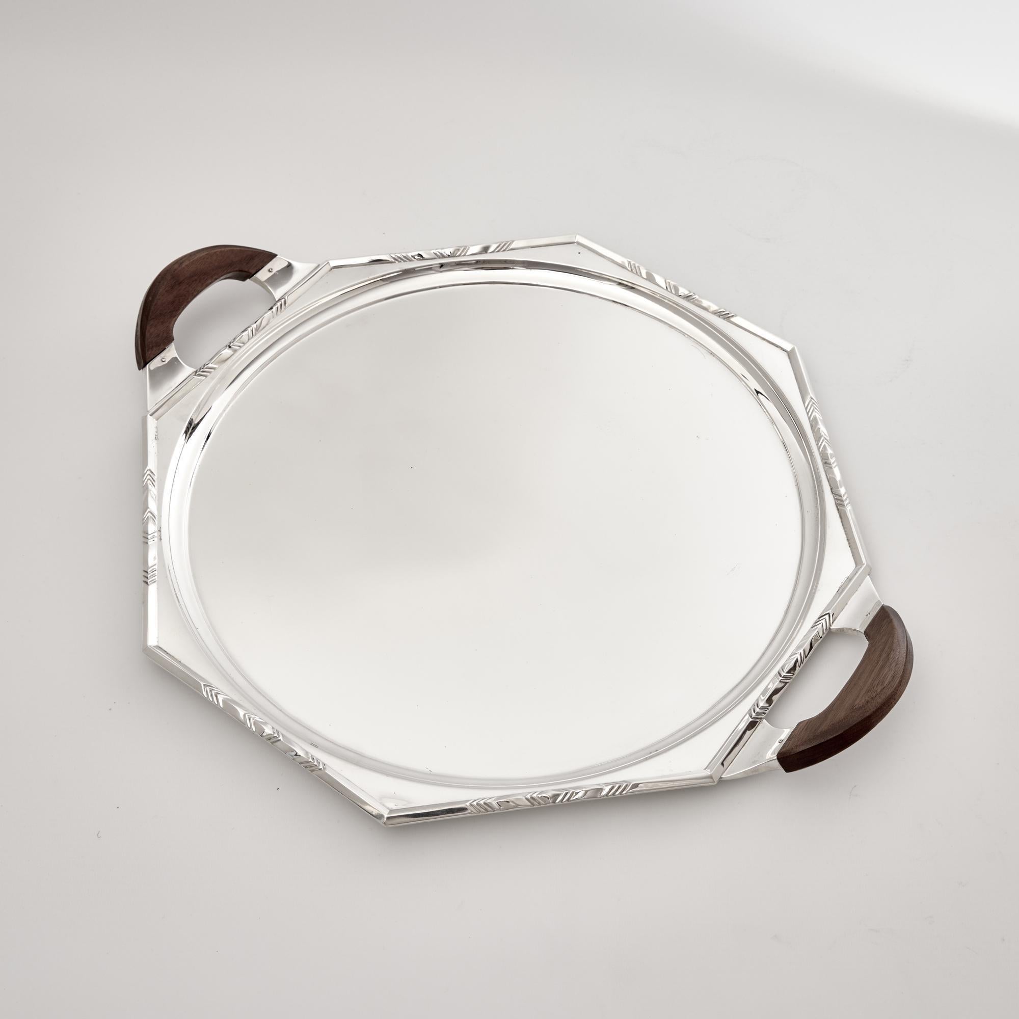 Designed and signed by J W Dibble, this is a stylish silver drinks or cocktail serving tray from the Art Deco period and bears a George V silver anniversary hallmark. The heavy-gauge tray features an applied mount to the panelled border decorated