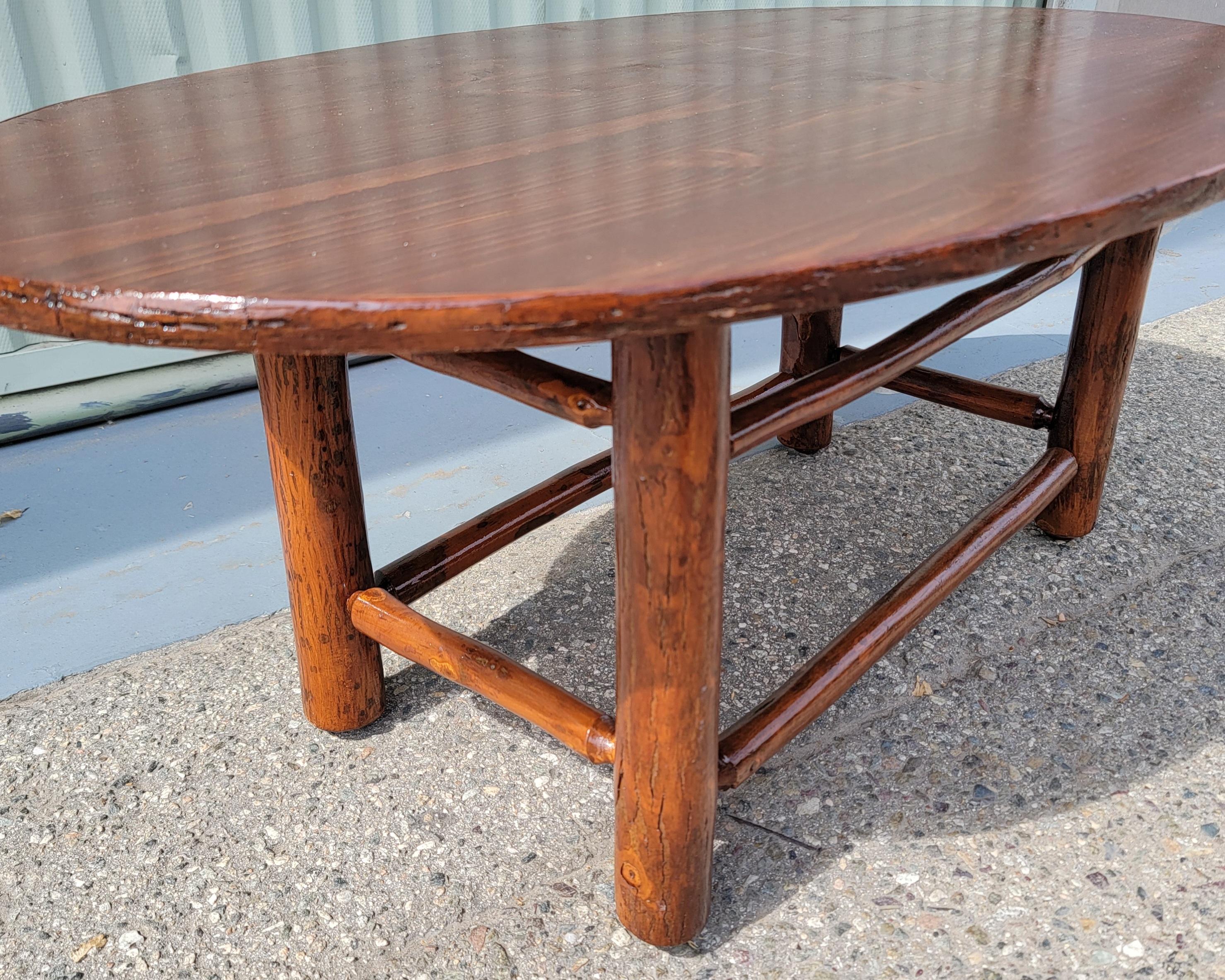This fine and most unusual shape Old Hickory coffee table is in pristine condition.Protected with Marine varnished top for water or beach protection.This keeps it safe in bad weather on a covered porch or patio.Signed Old Hickory @ Shelbyville