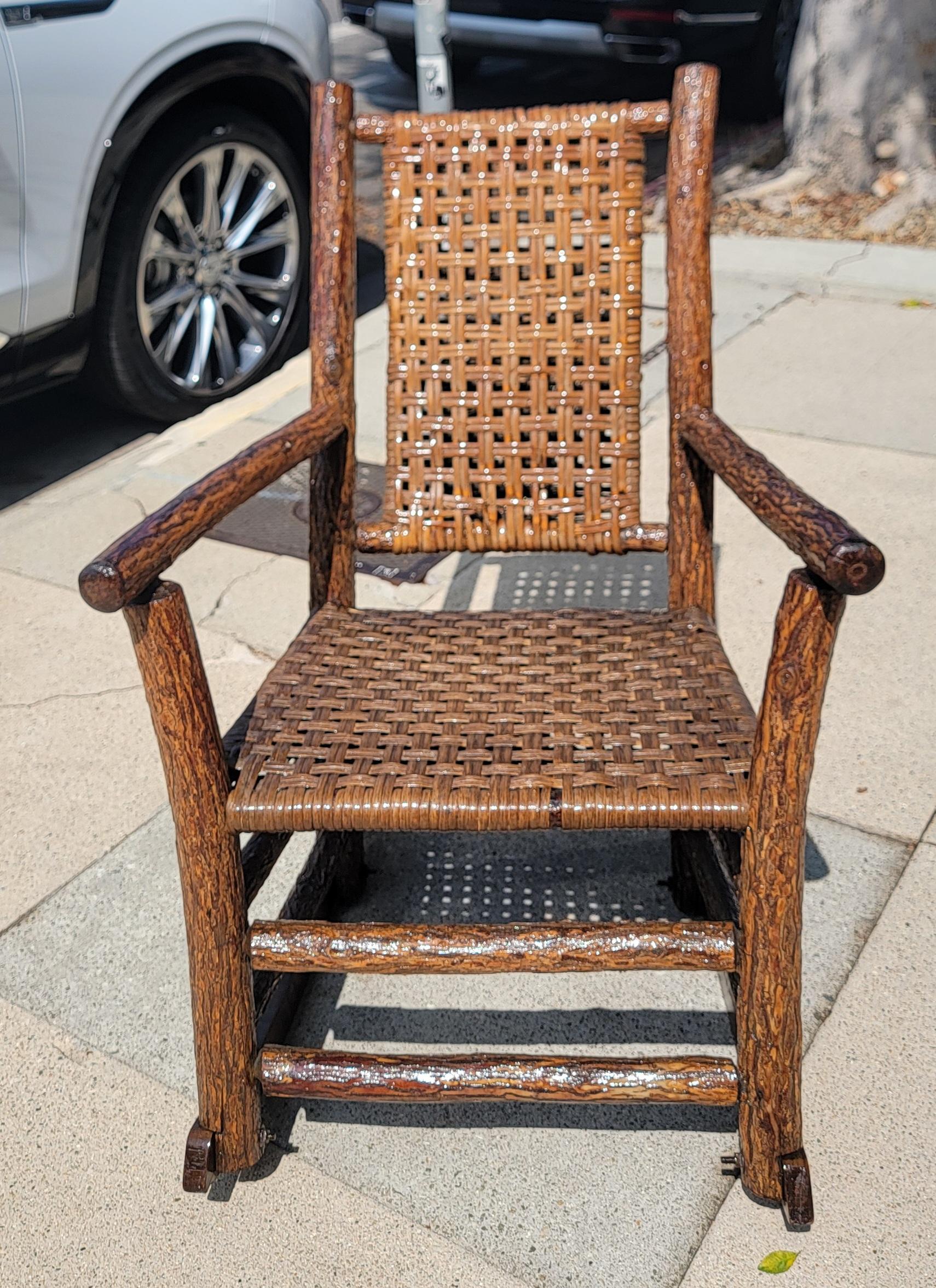Signed Old Hickory Rocking chair with original woven  seat and backing.The condition is very good and sturdy.Wonderful worn patina.