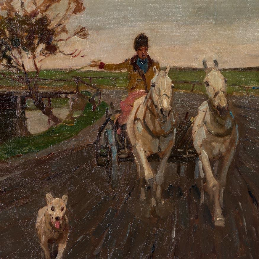 This original oil on canvas landscape from Hungary features a dog leading 2 horses and buggy on a country road. The canvas is signed Juszko in the lower left (Bela Juszko 1877-1969) and mounted in a painted wood and gesso frame. There are light