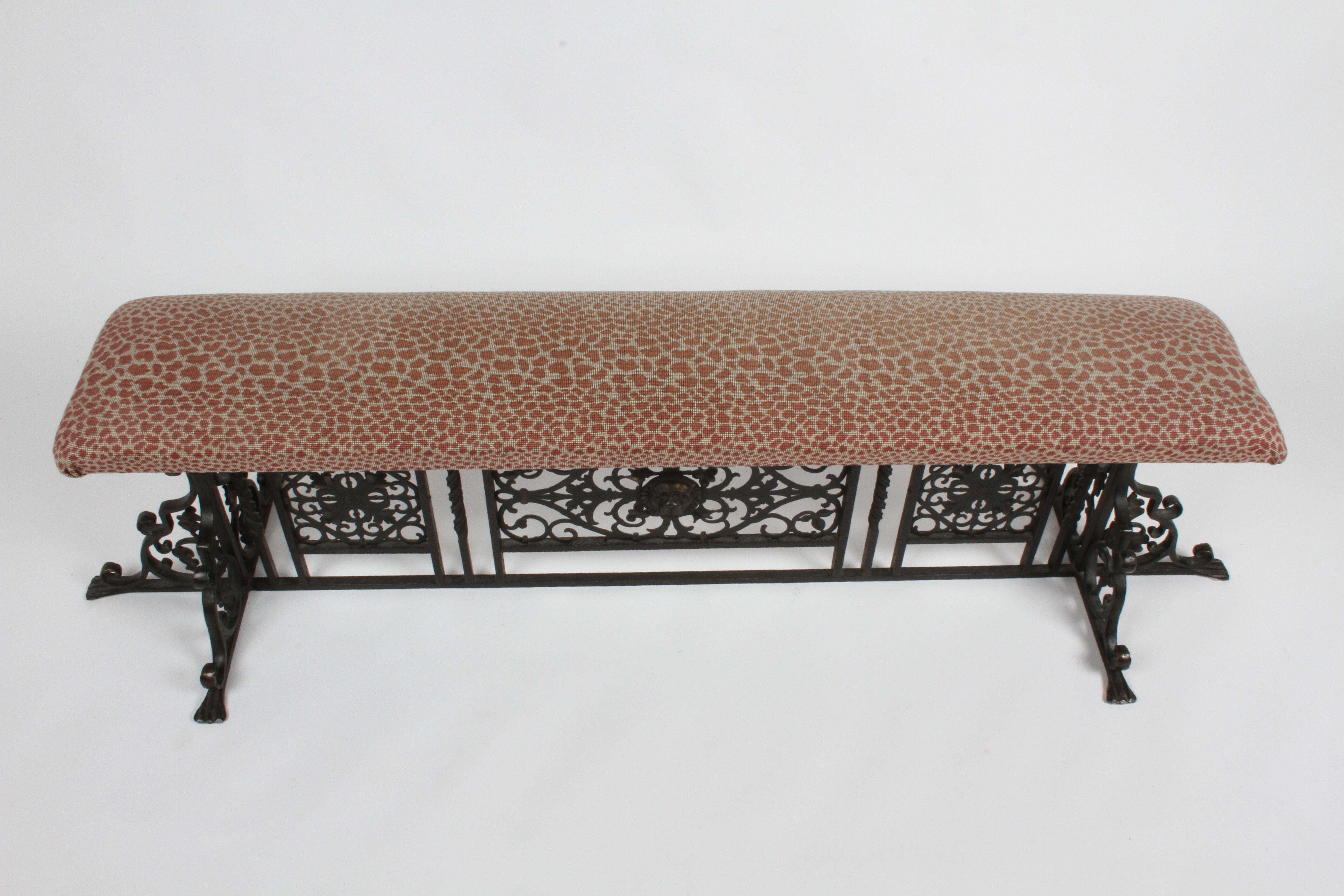 Scarce bronze hall bench designed by famed designer Oscar Bruno Bach (1884-1957). Over 6' bench with lion head, hand wrought, hammered, twisted bronze and fret work on faux leopard print upholstery seat cushion. Signed to the underside with Bach