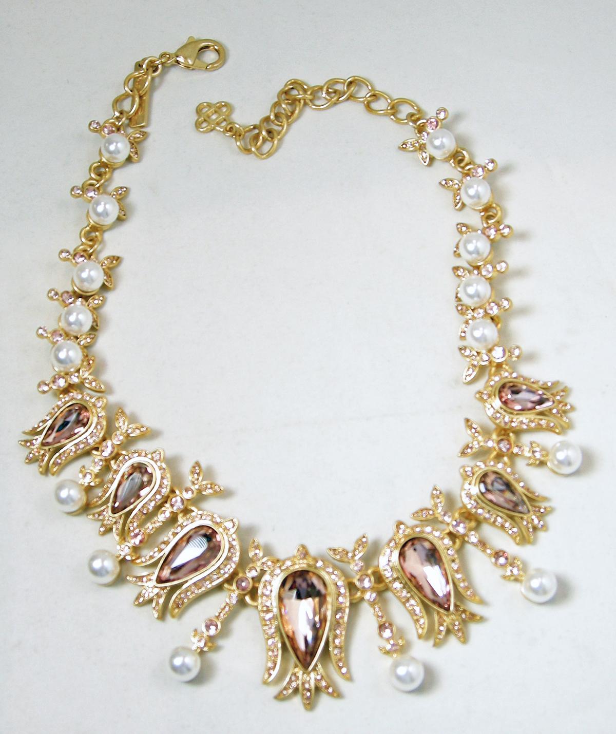 This signed Oscar de la Renta necklace has faux pearls with light amethyst crystals with clear crystals accents  in a gold tone setting.  This necklace measures 18-1/2” long with a spring clasp x 1-1/2” wide at the center.  In excellent condition,
