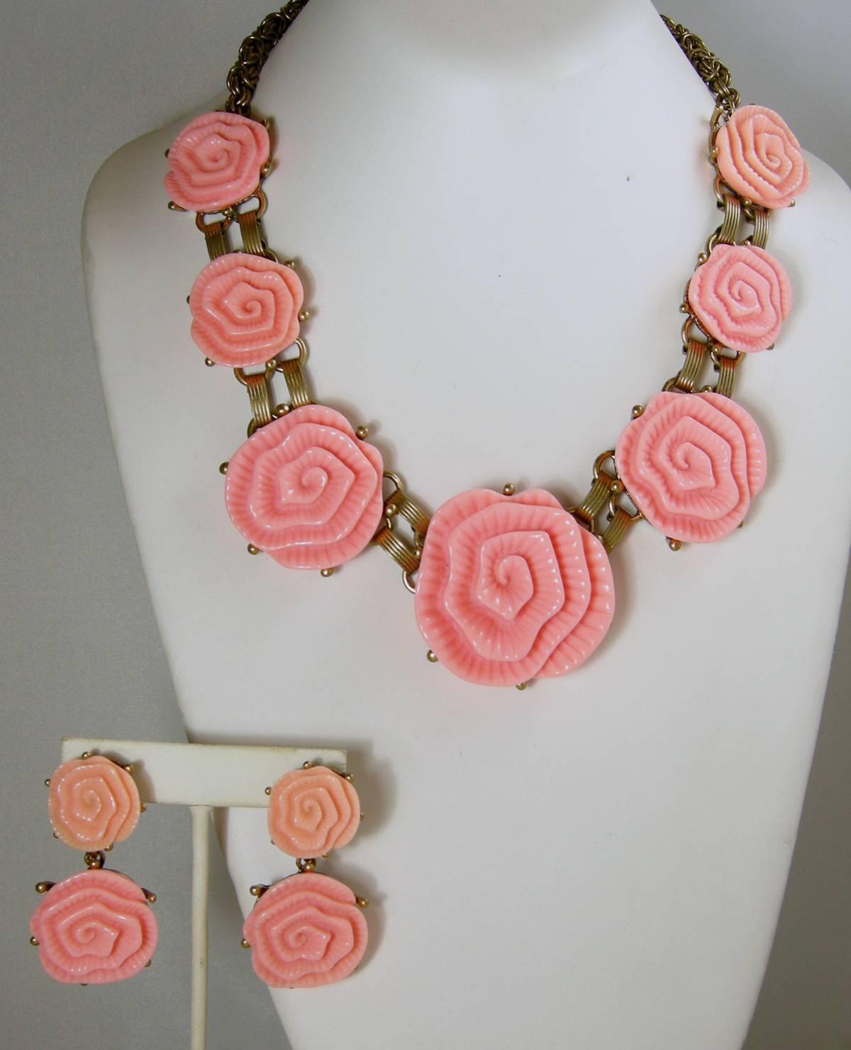 This is the perfect necklace and earrings for the summer.  It is an Oscar de la Renta pink camellia runway necklace with seven camellia flowers graduating in size to the middle.  All the flowers are carved resin connected to a book chain back in an