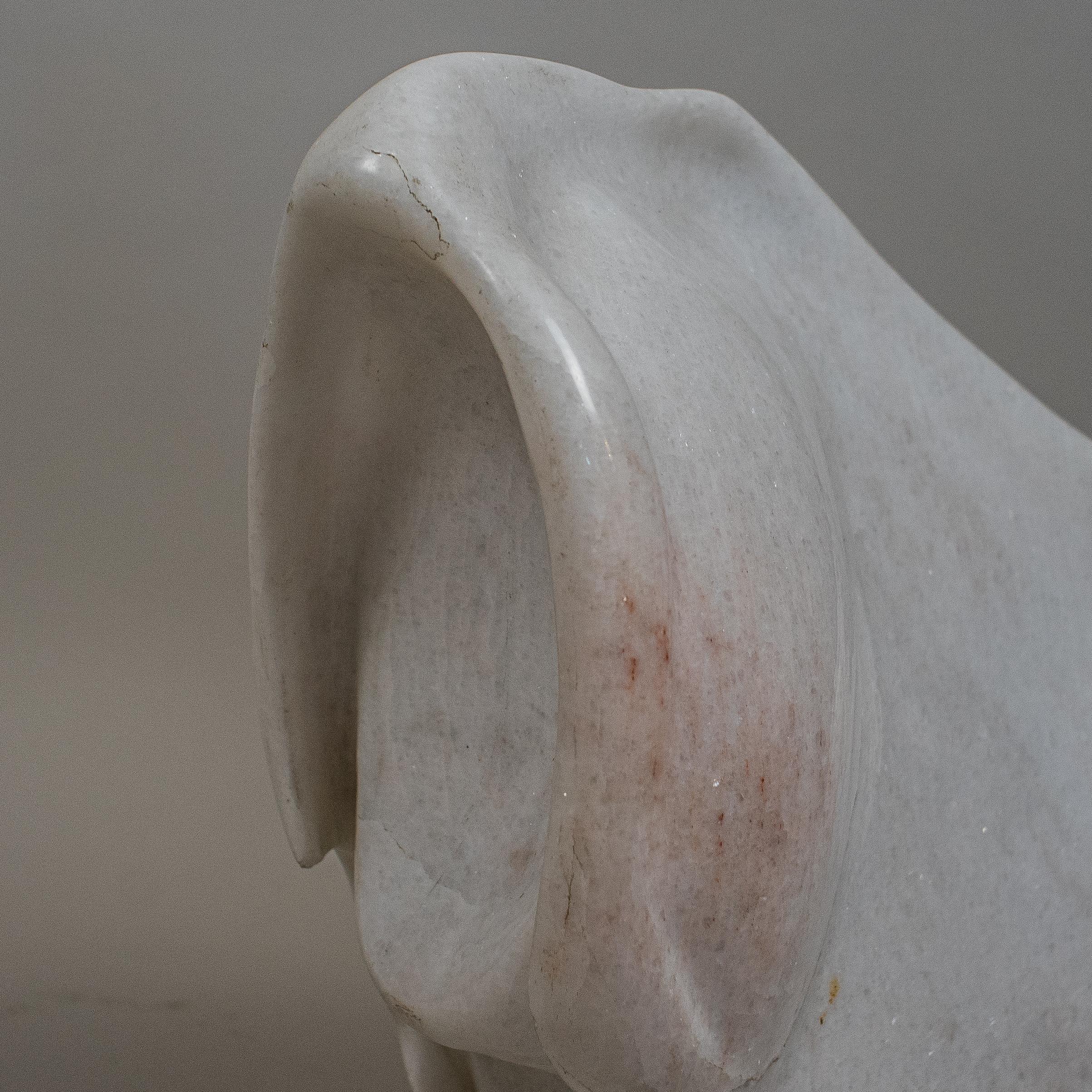A white marble abstract sculpture signed Osmond. Dated 91. The white marble sculpture shows some mild shades of pink.