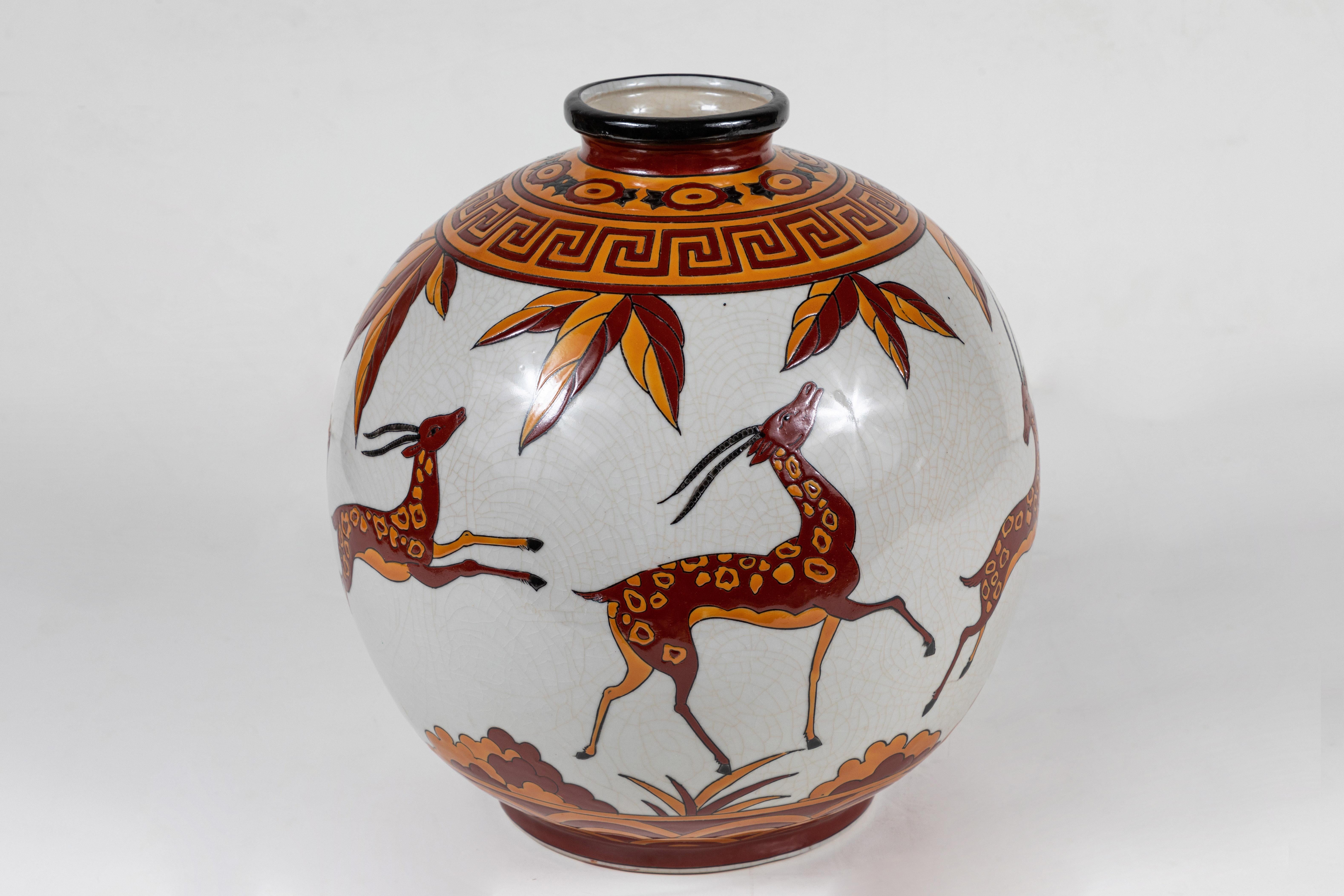 A wonderful pair of globe form vases in the Art Deco style, enameled and craquelured ceramic from the famous Boch Frères Keramis foundry in La Louvière, Belgium. Decorated with storks and leaping gazelles amdist foliage. Each marked on their bases.