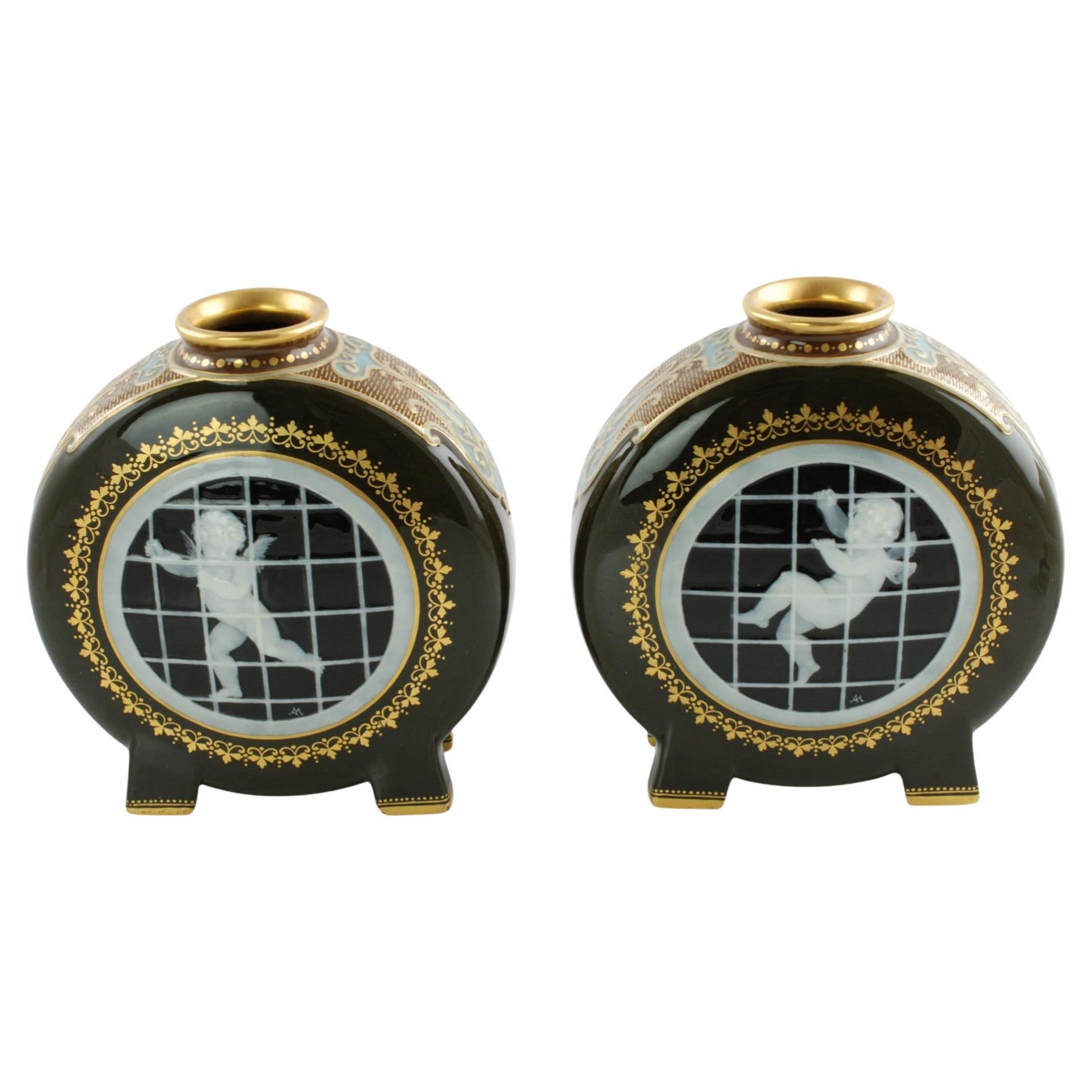 Signed Pair Gilded Mintons Pate-Sur-Pate Caged Putti Footed Moon Flask Vases
