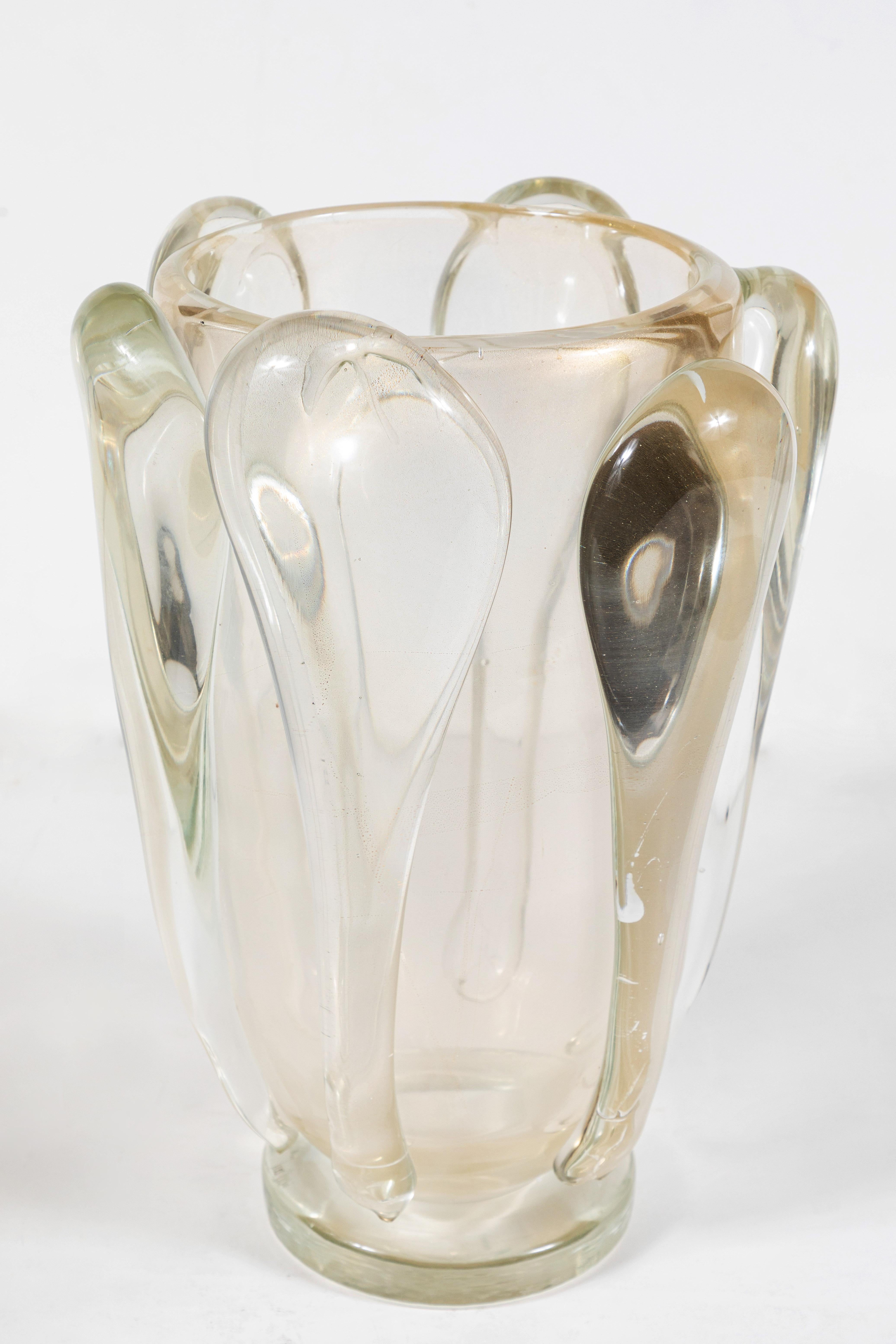 Beautiful, hand blown, midcentury pair of organic-style, Murano glass vases embedded with gold flecks. One of the pair is signed on the underside.