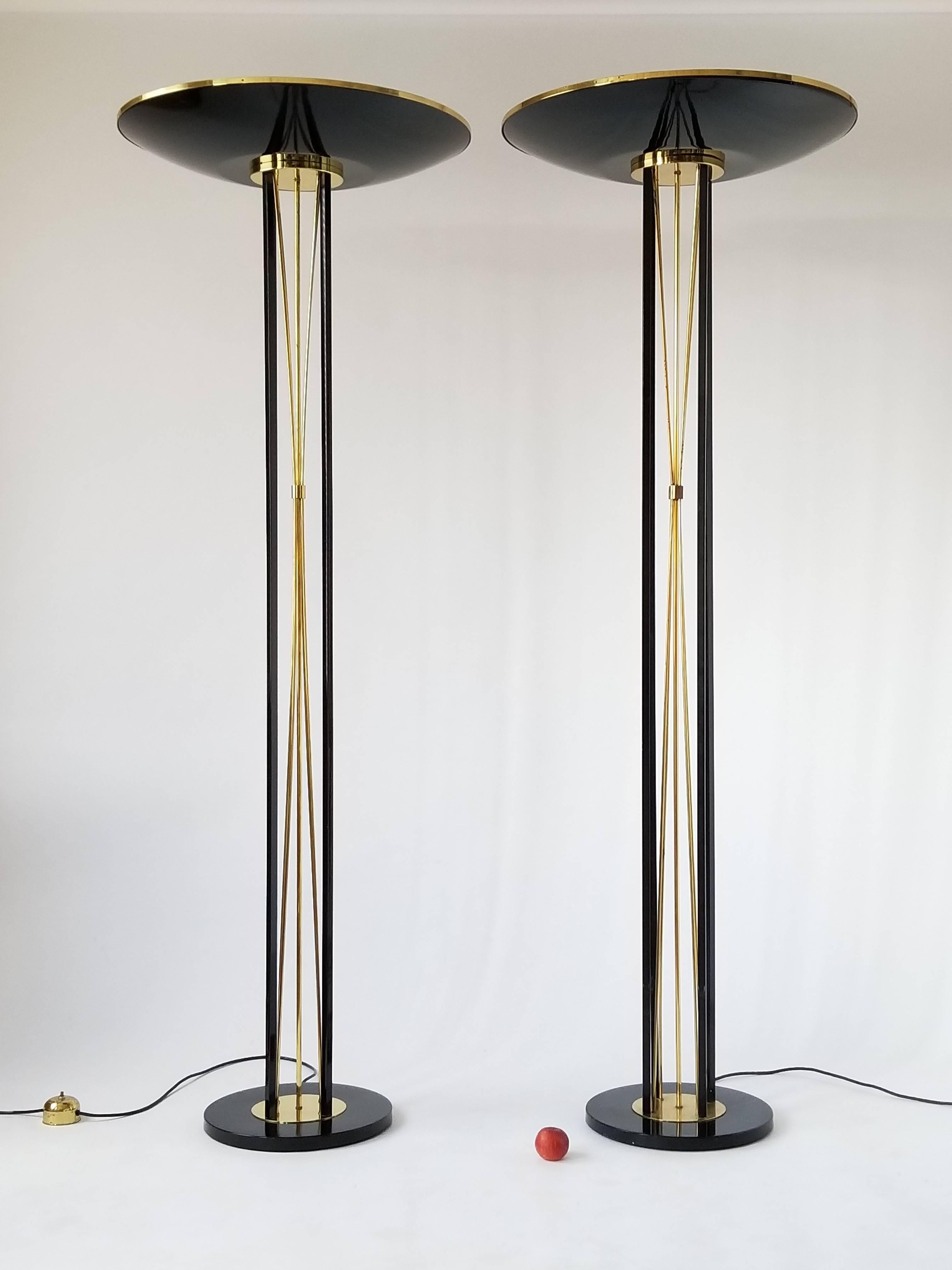 Minimalist Art Deco/ neoclassical   Reggiani torchiere. 

In a glossy enameled black steel with solid brass rods and trim.

Another  set of 2 is availaible in a light butter cream tone  .

Well made with prime quality material.

Measure 74.5 inches