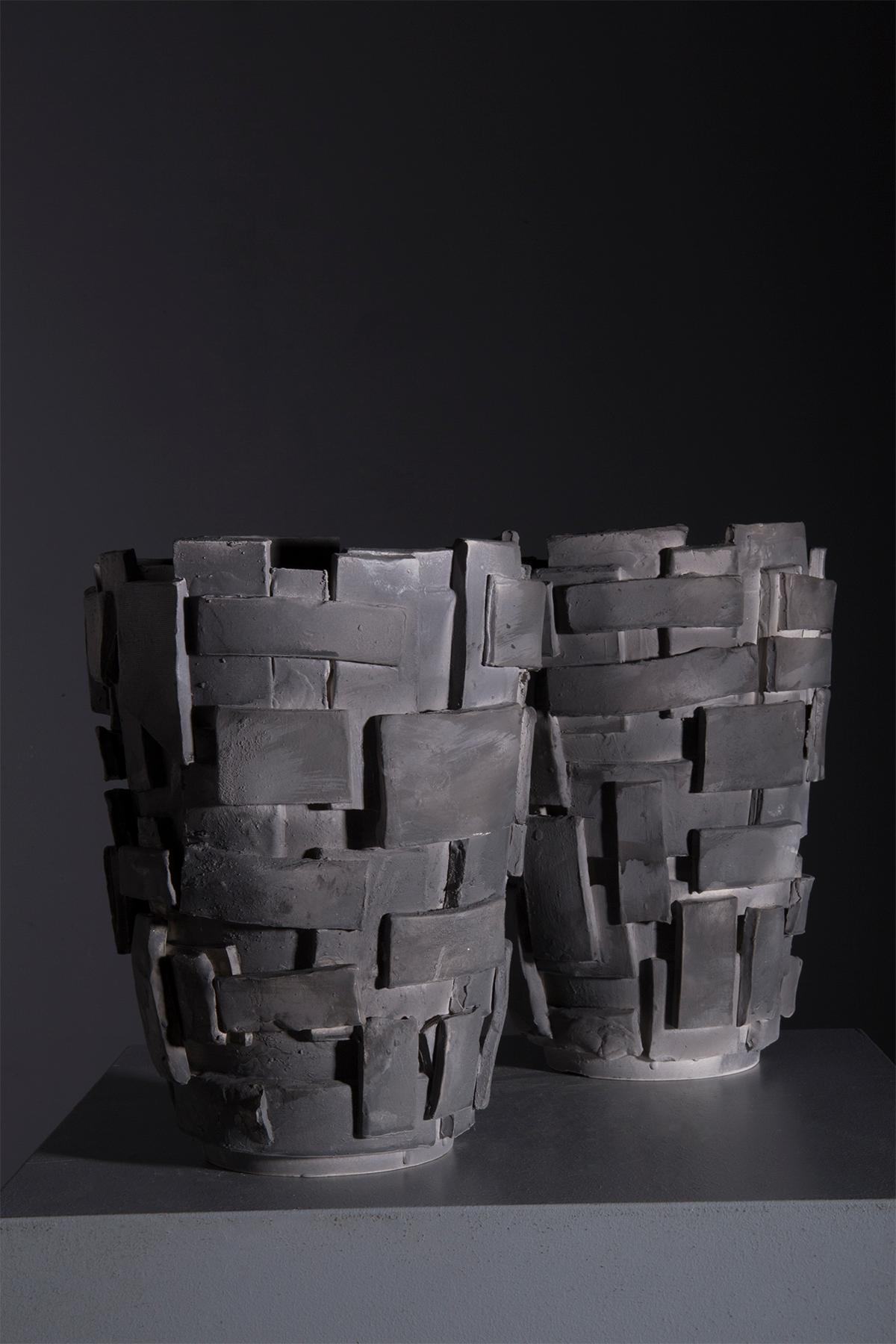 This stunning pair of ceramic vases is a true masterpiece of contemporary craftsmanship. With their bold design and rich texture, these vases are perfect for adding a touch of sophisticated modernity to any space. Made from high-quality ceramic,