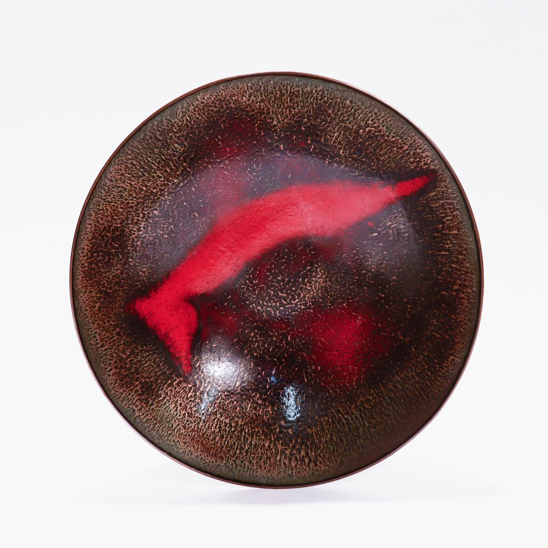 A fine large modernist bowl.

In copper and enamel.

By Paolo de Poli. the world-renowned Italian enameller and painter.

The interior decorated in black and red enamels and the exterior with a thin, translucent baby blue enamel (with large windows