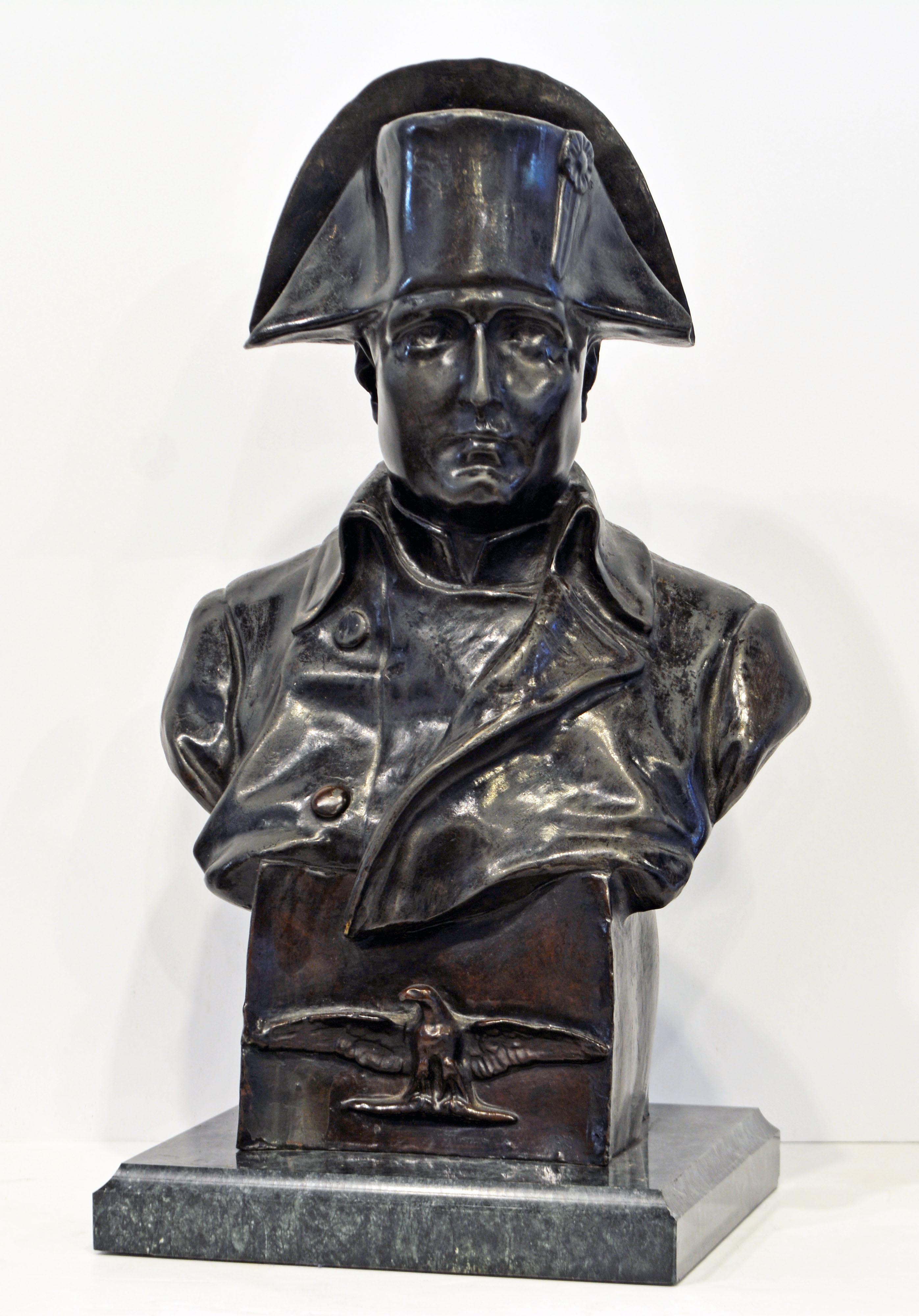 This late 19th century bronze bust signed by Rafaello Nannini (Italian 1852-1895) features a boldly sculpted portrait of Napoleon I wearing his legendary two corner military hat. The bust rests on a bronze plinth decorated with the imperial eagle in