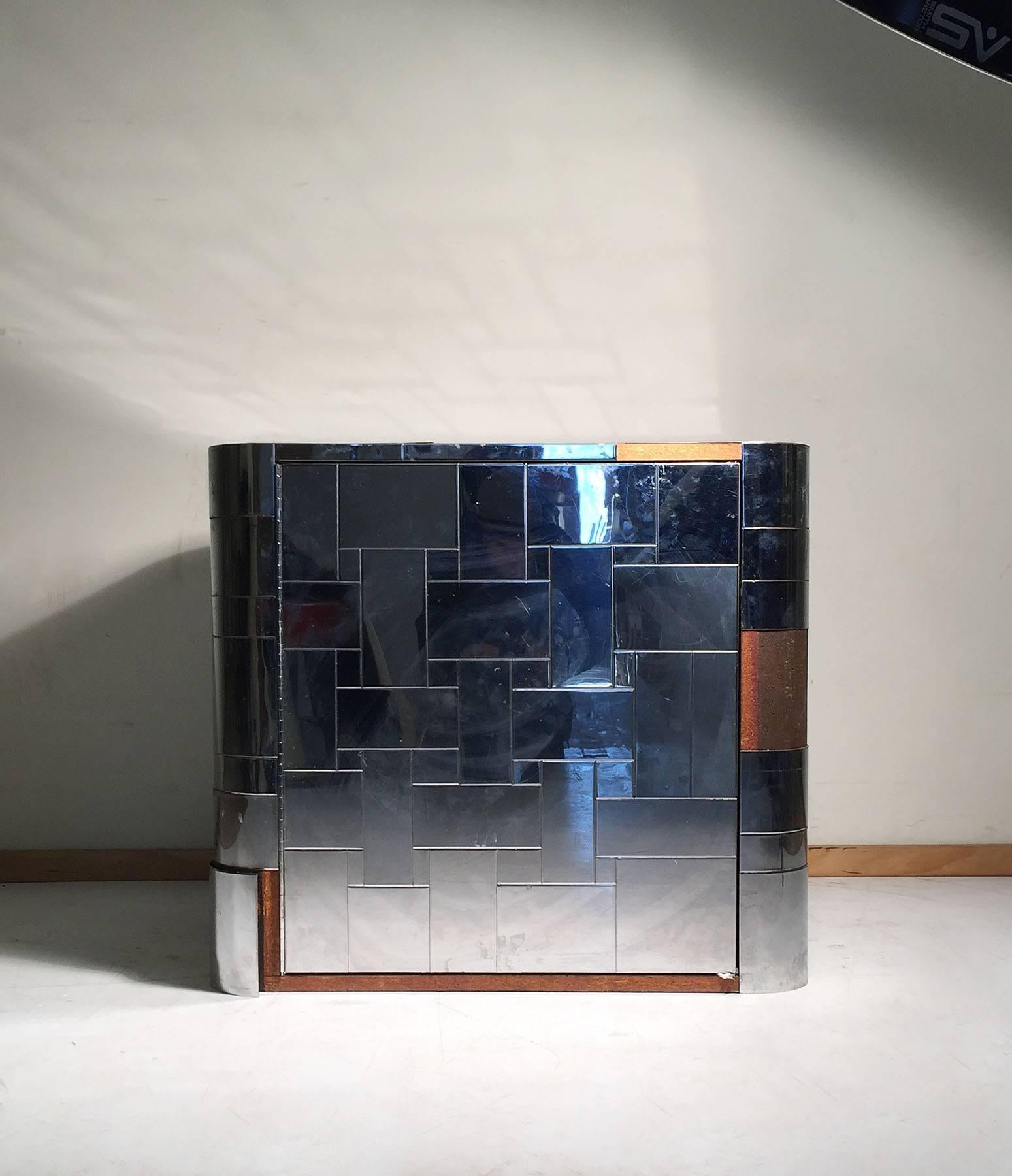 A nice Signed Paul Evans small cabinet with a floating shelf on interior. This can be used as a single End table or nightstand as well. Or can serve as a Pedestal cabinet for sculpture.  

This is an opportunity to acquire a vintage signed Paul