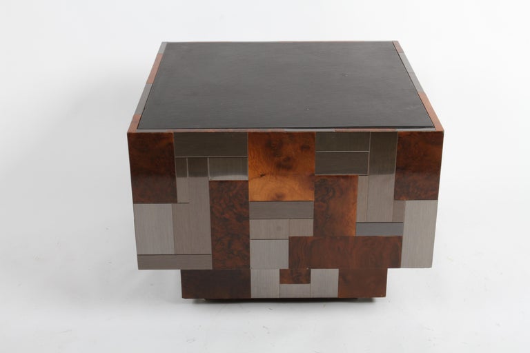 Mid-Century Modern Signed Paul Evans for Directional large patchwork end table on castors. This is uncommon with the combination of dark gray / pewter colored steel and burl wood tiles with a black slate top. In fine condition, only minor wear with