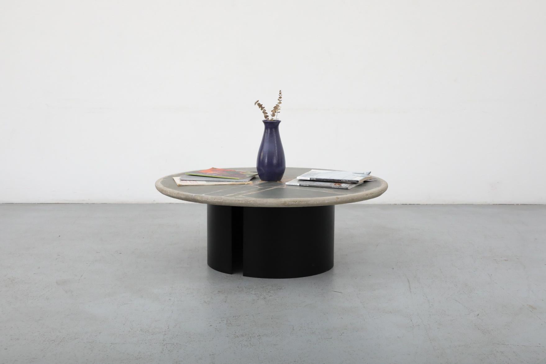 Signed Paul Kingma round cement mosaic coffee table with brass accents. Dutch artist and designer Paul Kingma designed mosaic stone coffee table with embedded mixed materials, stone and metal fragments. He saw his tables as a self-contained design -