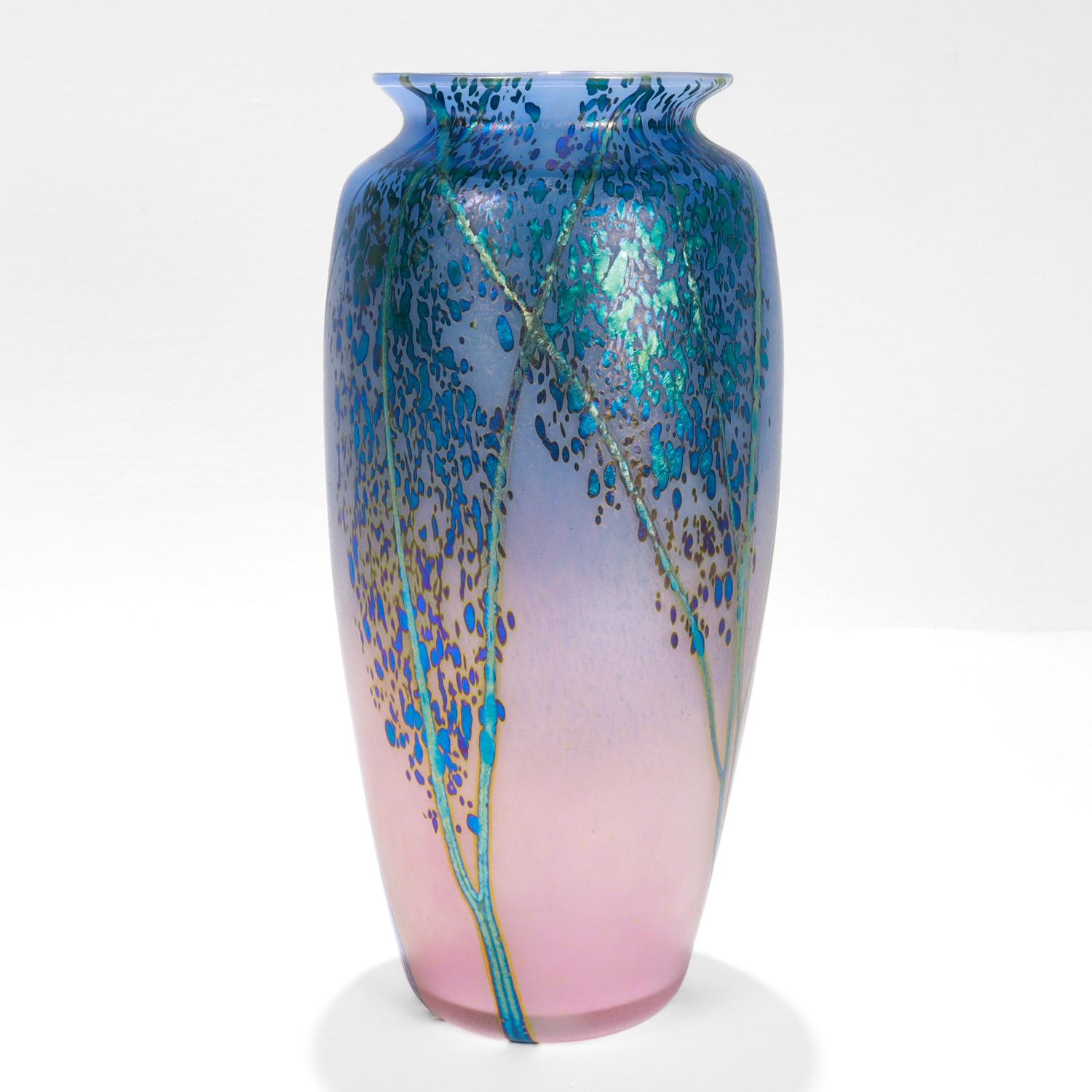A fine American contemporary art glass vase.

By Peet Robison.

From his Sunset Landscape series. 

The vase depicts an abstract landscape with a blue to pink sunset background and iridescent blue/green trees in silhouette. 

Peet Robison was a