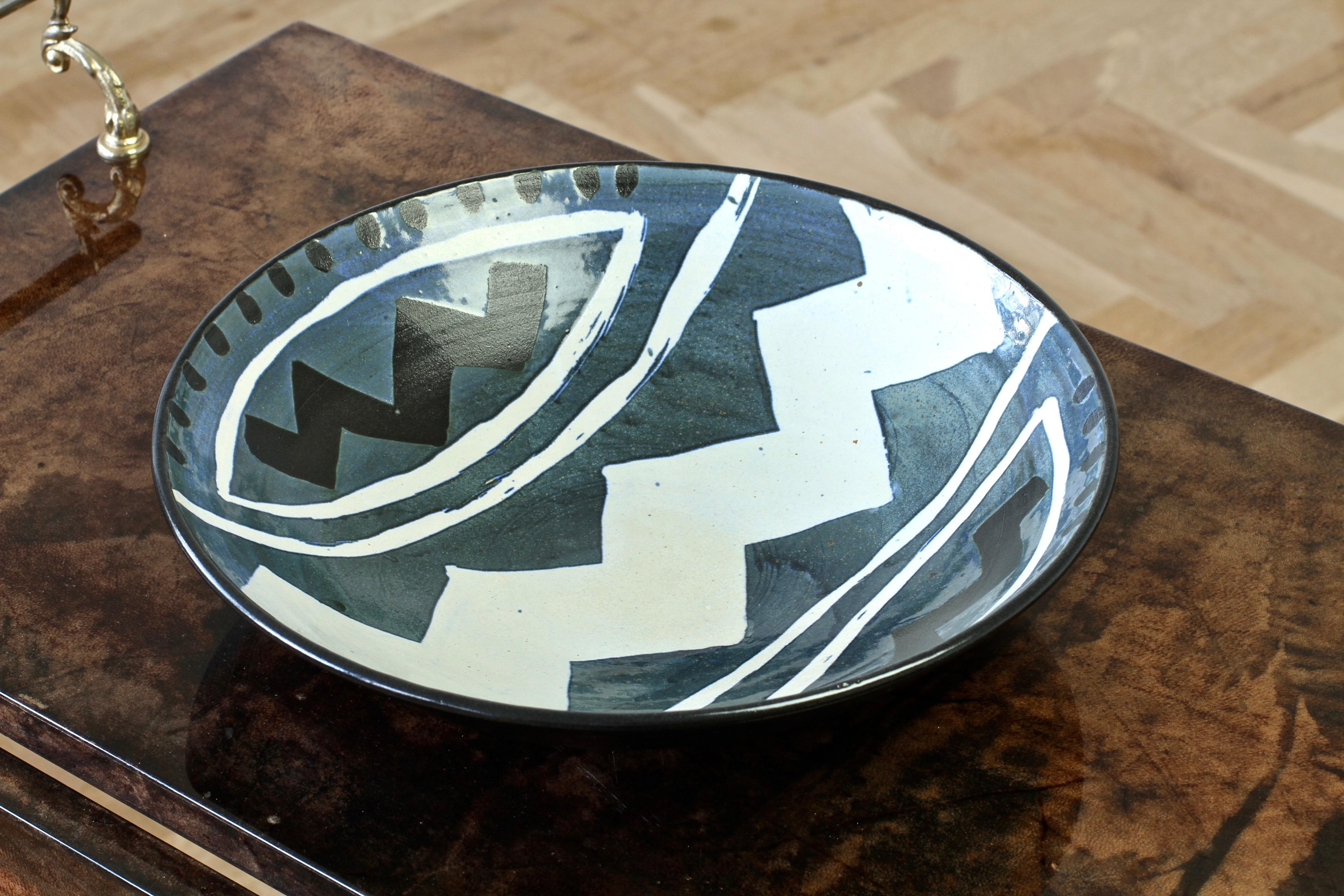 Signed studio art pottery bowl, unattributed. The decoration on this piece is simply wonderful with the 'African' geometric pattern in white, black and blue. A wonderful piece of pottery.

     