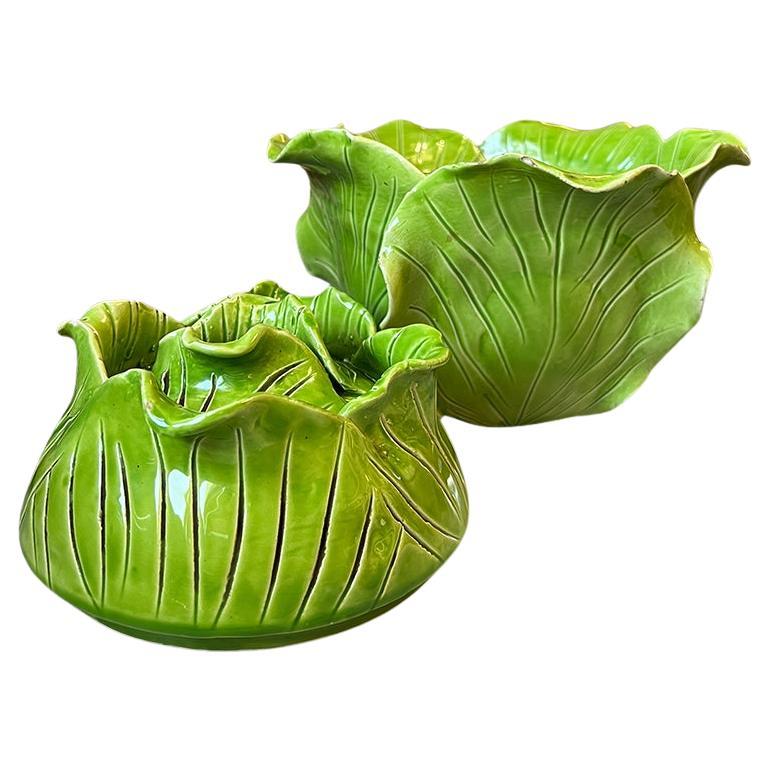An incredibly beautiful and rare Hollywood Regency ceramic tureen by French artist Jean Roger. This piece is created by hand and features delicate bright green cabbage or lettuce leaves that are applied around the body by hand. The lid features the