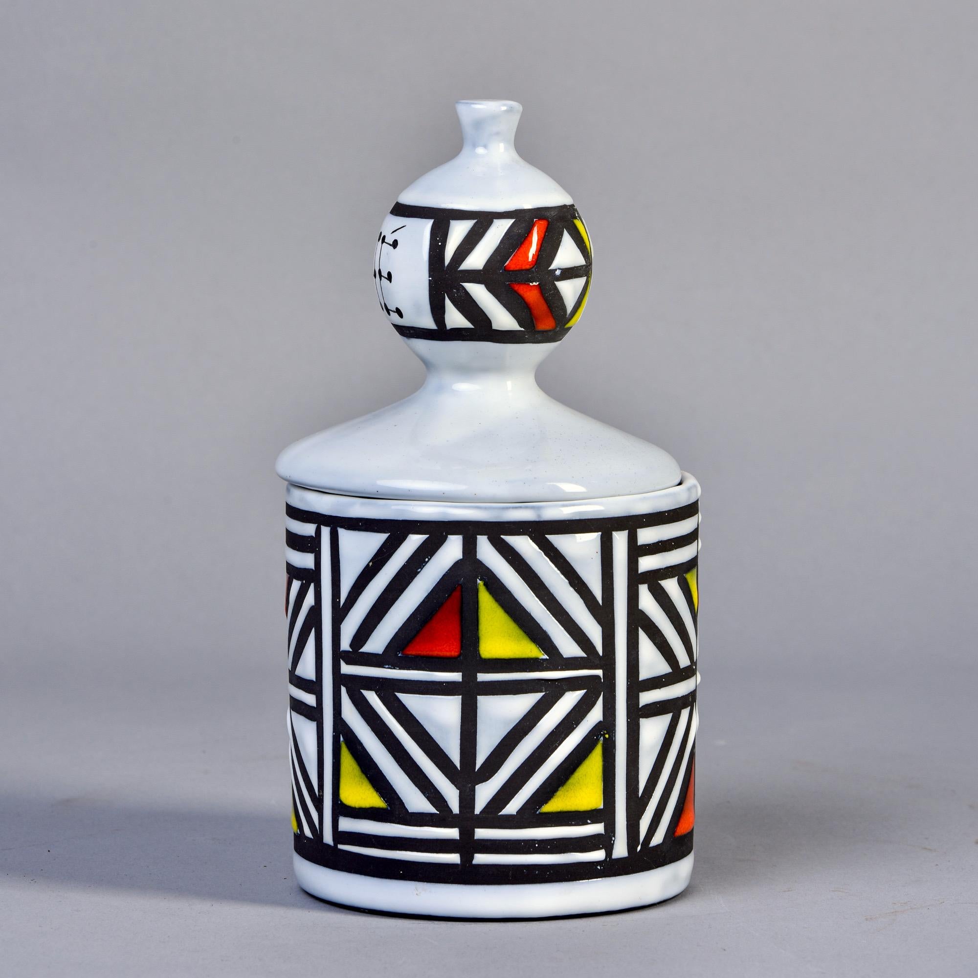 Signed ceramic tea canister by Roger Capron in his iconic black and white plus color block style, circa 1960s. Signed on the underside of base with artist name, Vallauris, France. Numbered M74 on underside of base and lid. 

No flaws found.