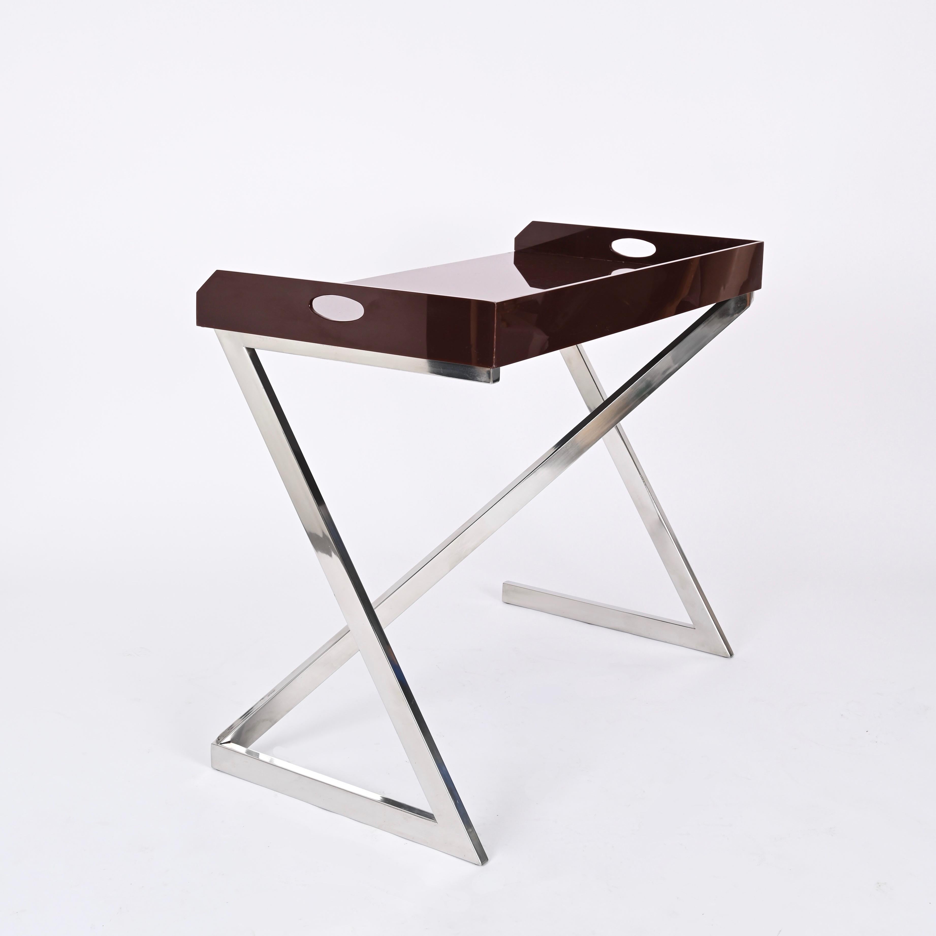 Superbe bureau ou table console en acier chromé avec un plateau en plexiglas brun. Cette pièce incroyablement rare est signée par Romeo Rega et a été conçue à Romeo, en Italie, dans les années 1970.

Cet objet élégant et polyvalent peut être utilisé