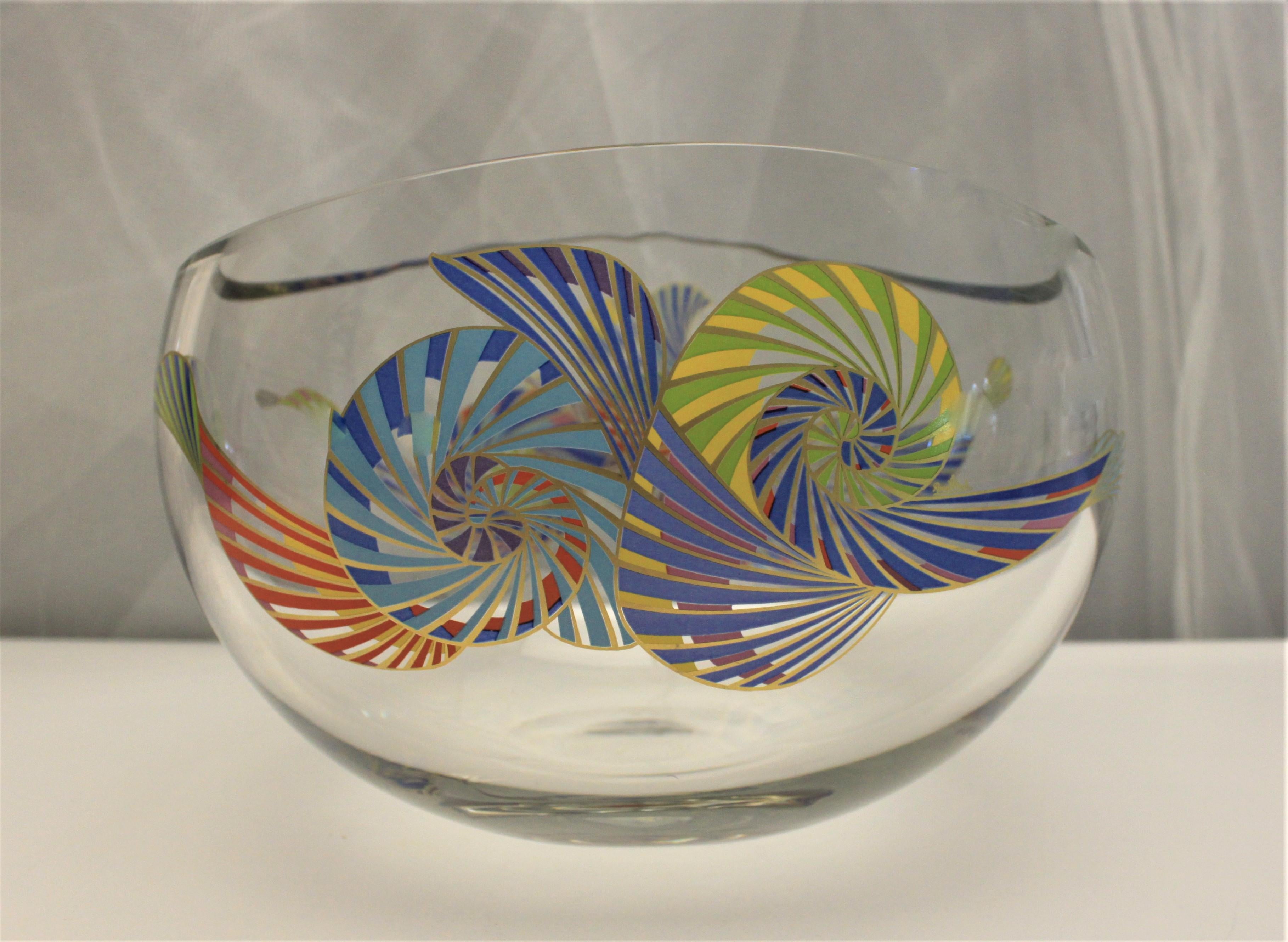 This signed Rosenthal elliptical crystal centerpiece bowl was likely made in the Late 20th century and in the Modernist style in both form and decoration. The bowl is colorfully decorated on both sides in very vibrant painted or enameled hues. The