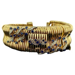 Manschettenarmbanduhr, signiert ""Ruser"" 14KT YG & Plat Dia & Saphir