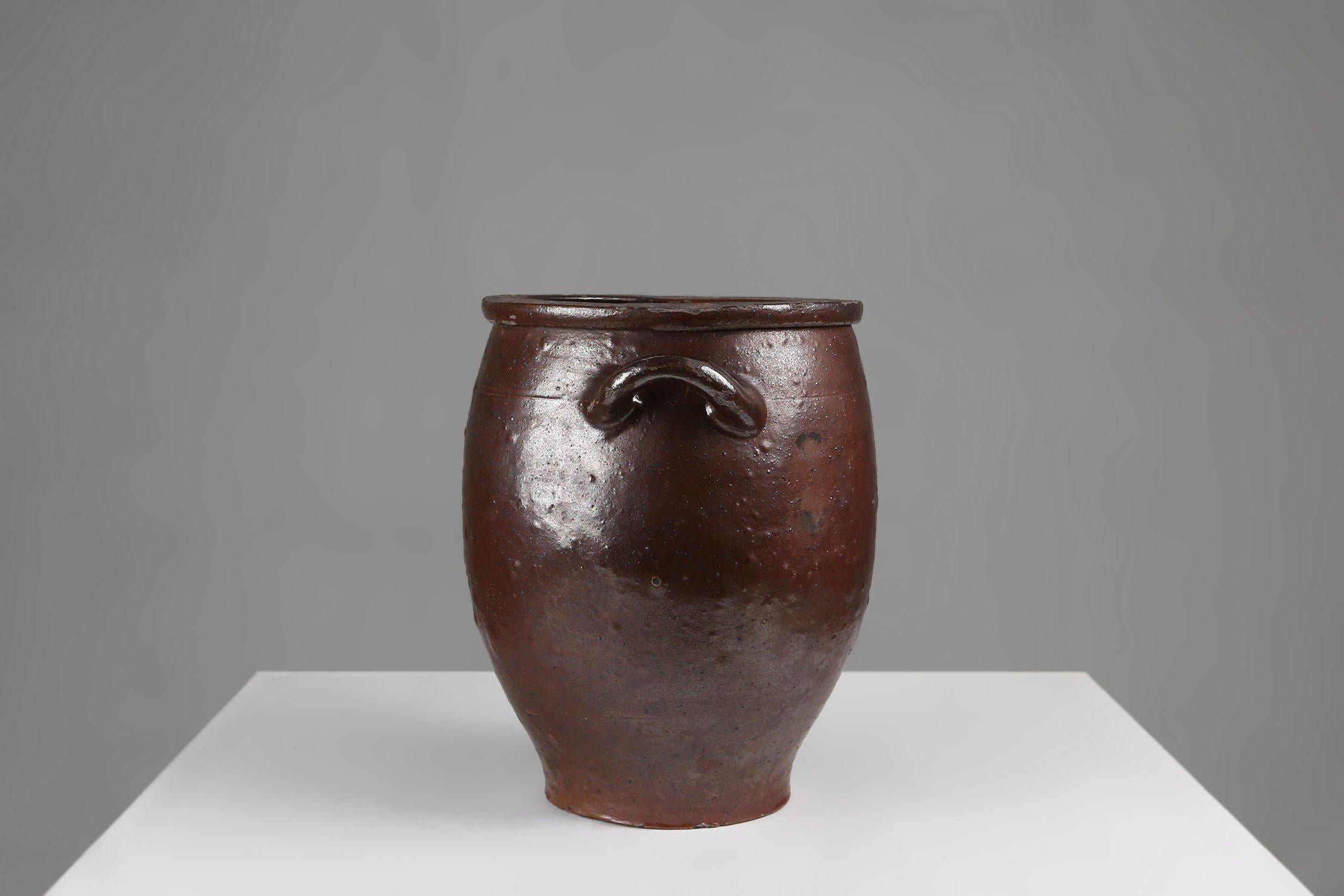 Belgio / 1800 / antico / ceramica / vaso / marrone smaltato   

Questo squisito vaso marrone rustico di grandi dimensioni con manici elegantemente lavorati sulla parte superiore è un vero capolavoro di arte ceramica. Realizzato a mano con la massima