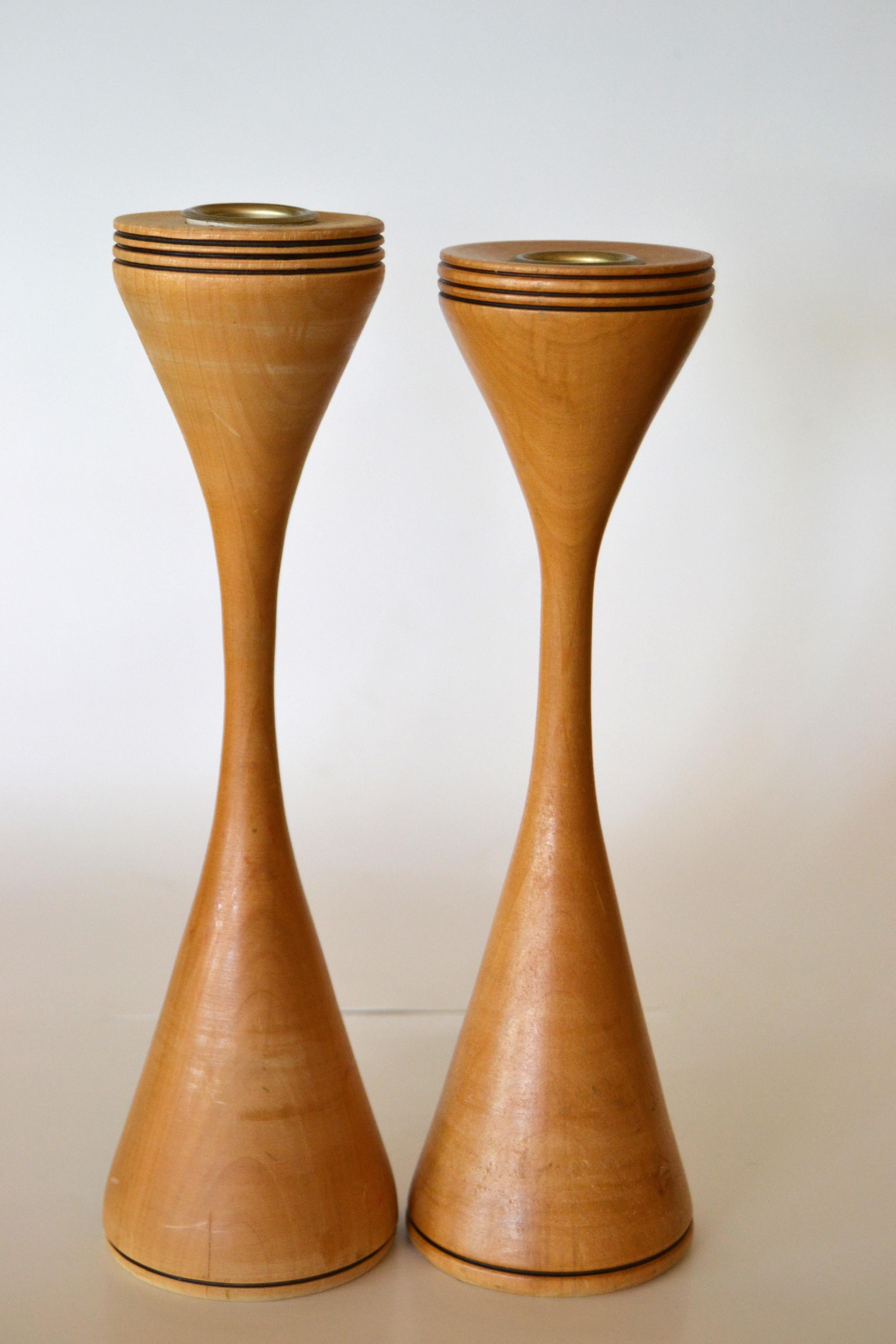 A pair of signed Scandinavian Modern handcrafted turned wood and brass candleholders.
Branded signature by Artist underneath.