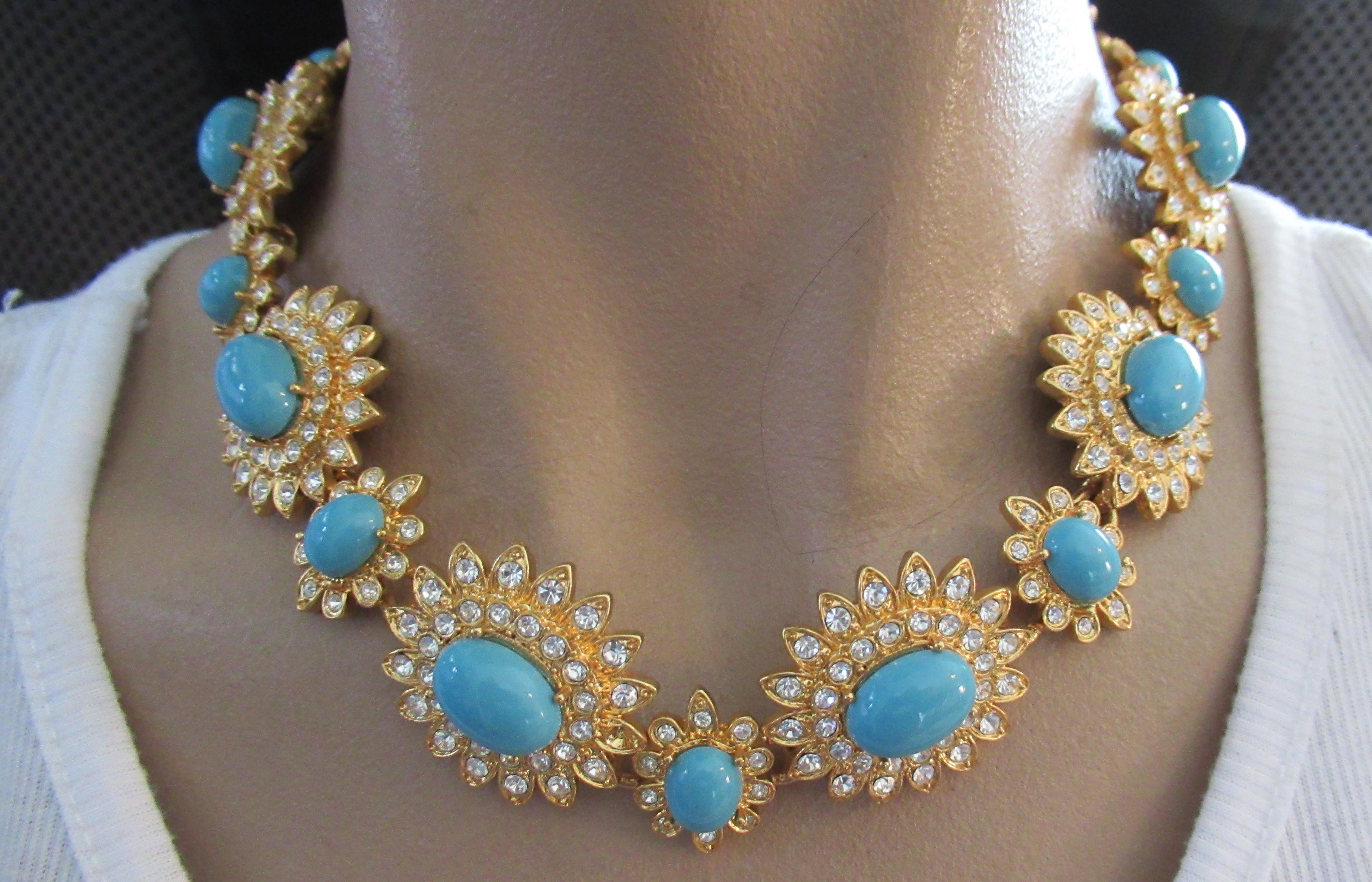 Beautiful and Stylish Vintage SCASSI Necklace. Each Floral link center Hand set with Faux Blue Cabochon Turquoise and surrounded by Sparkling Ice Crystals. Signed SCASS; Necklace measures approx. 16.5” Long and the large flowers are 1.25