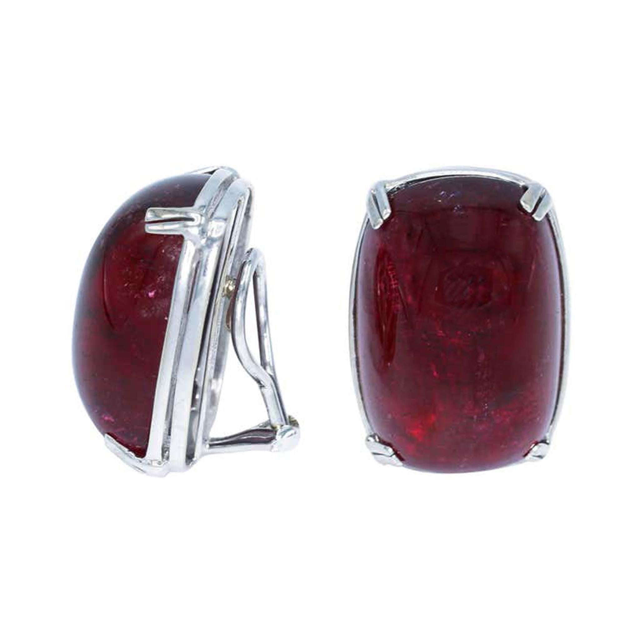 An unusual pair of large cabochon rubellite tourmaline clip-ons by the iconic jewelry house Seaman Schepps. These two large and well-matched size and color cabochon rubellite tourmalines are set in 18k white gold. They display an even deep red hue,