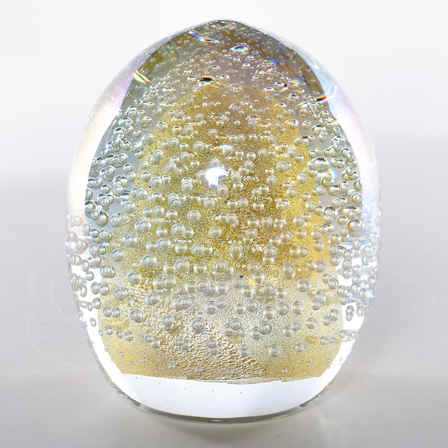 Seguso egg shaped paper weight in clear heavy glass with bubbles and gold inclusions, circa 1980s. Etched signature on underside of base. Two available at time of posting, sold and priced individually.