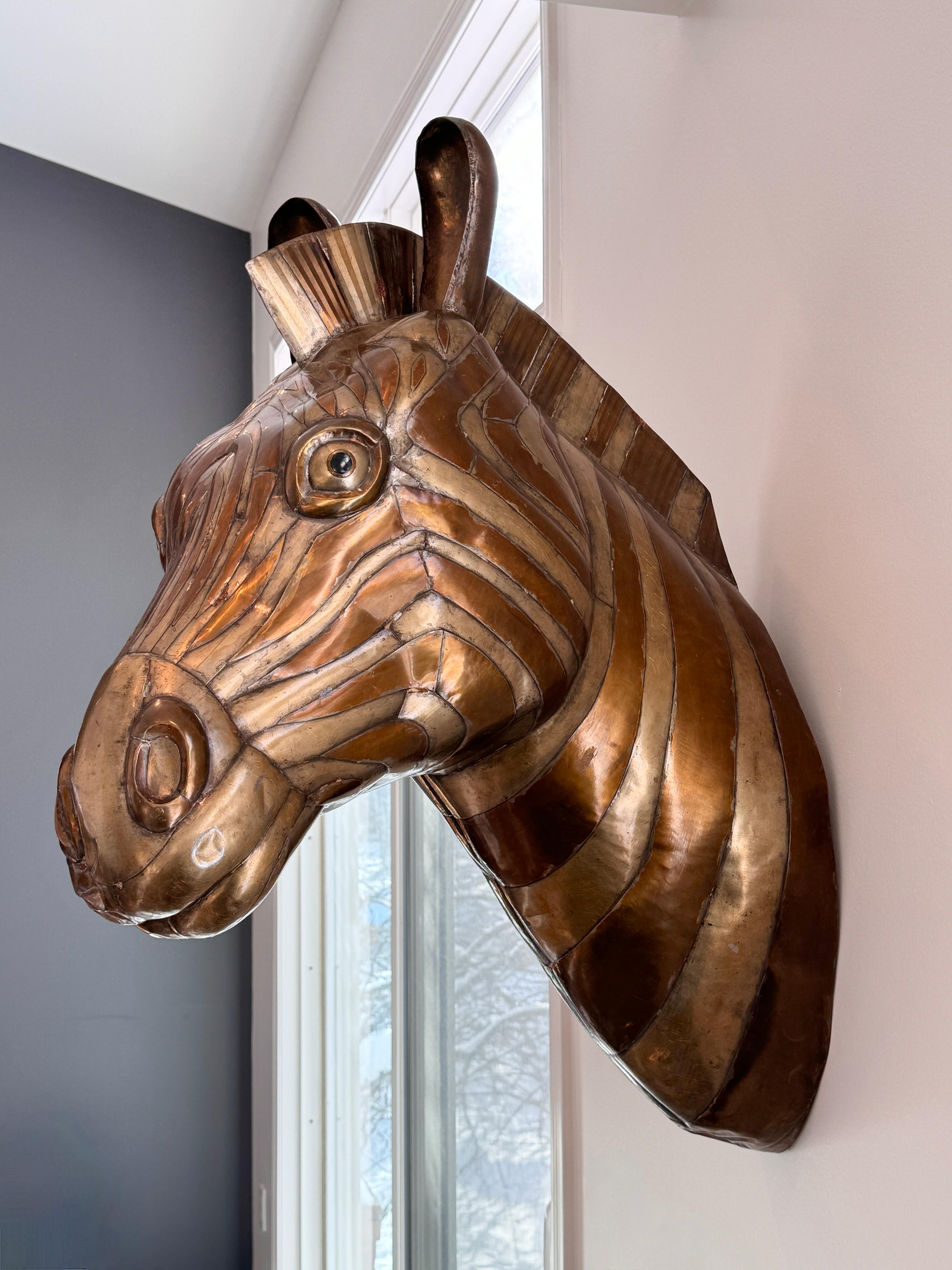 A signed Sergio Bustamante mixed metal wall sculpture circa 1970s

Zebra head mount formed of brass and copper with charming character and detail
Signed and numbered 80/100

16 inches wide
24 inches deep
32 inches in height
