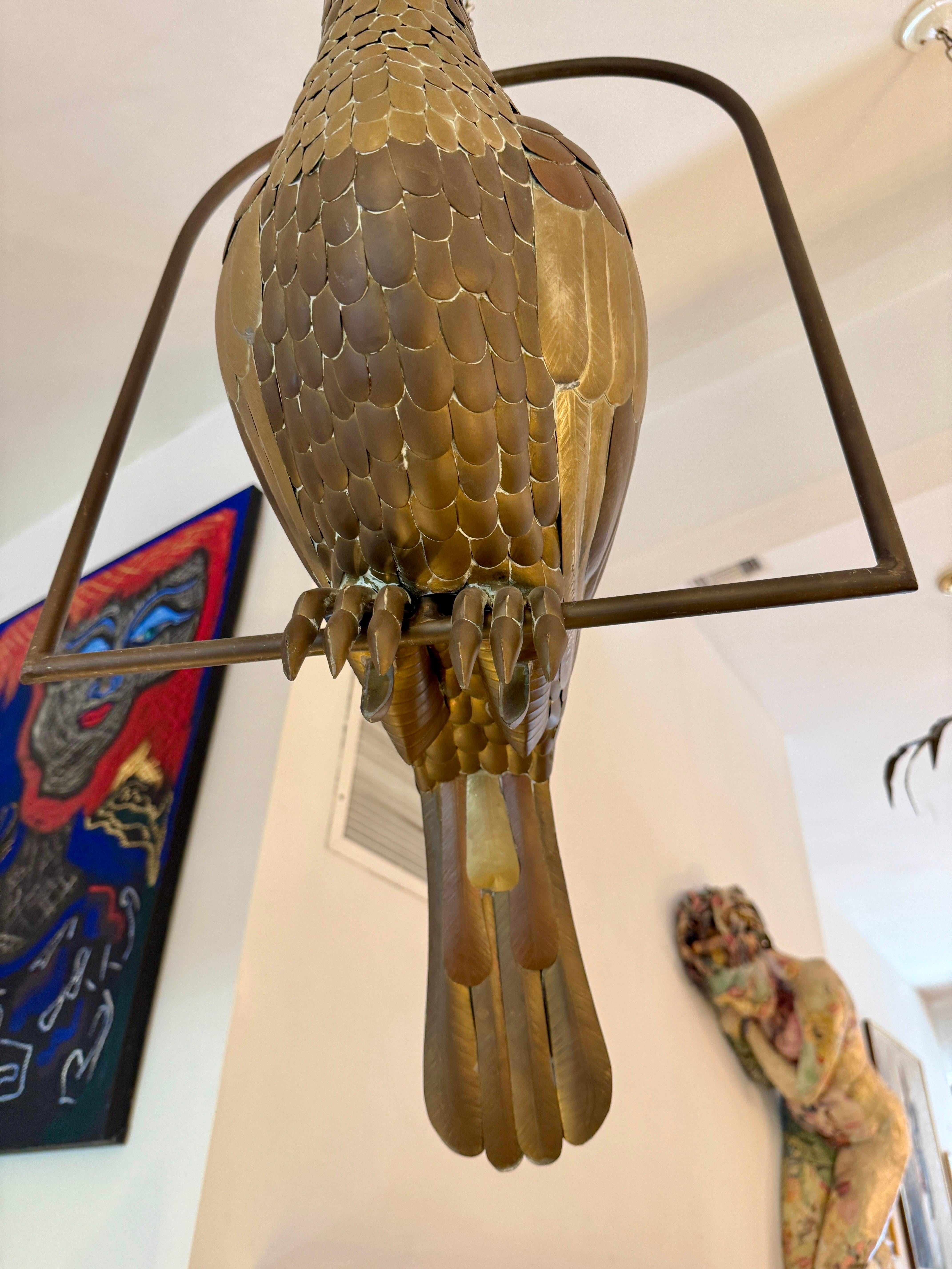 This is a stunning 1970s brass large tropical bird sculpture on a perch, by renowned Mexican artist Sergio Bustamante. The sculpture showcases Bustamante’s signature artistry, featuring individually sculpted feathers and a striking polished brass