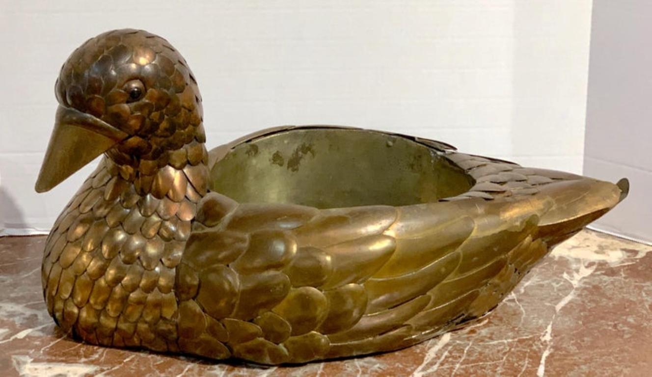 Signed Sergio Bustamante copper and brass bird centerpiece, realistically modeled with numerous layers of feathers, surrounding a 9.5 H x 8.5 D x 5.5 H bowl. Inscribed 'Sergio Bustamante'.
 