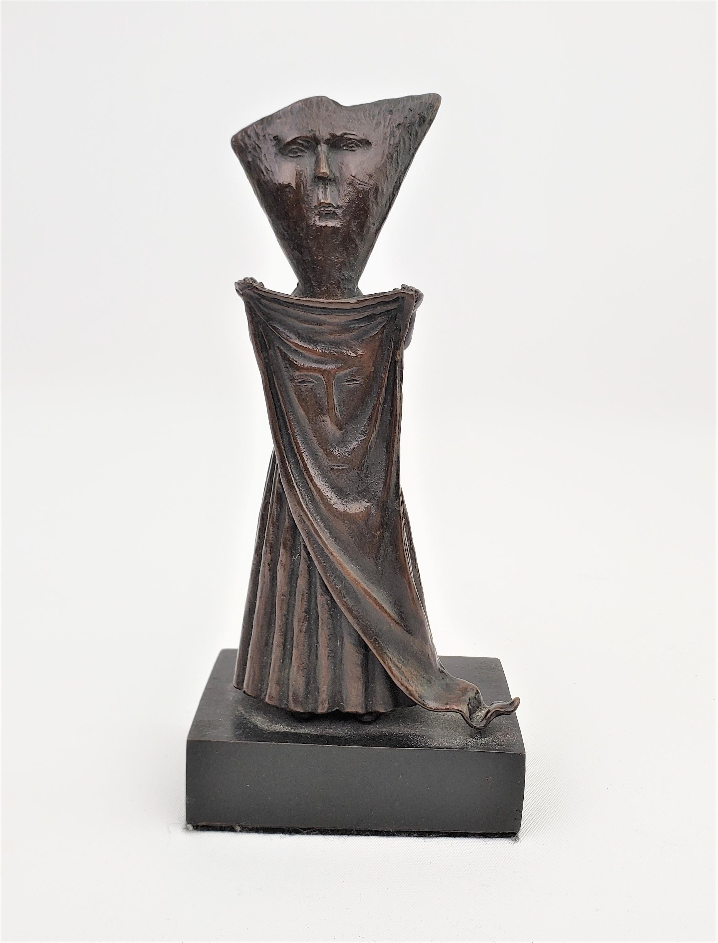 This signed Sergio Bustamante stylized figurative sculpture was made in Mexico in approximately 1970 in a Mid Century Modern style. This patinated bronze sculpture depicts and stylized or surrealistic robed standing person in his signature style.